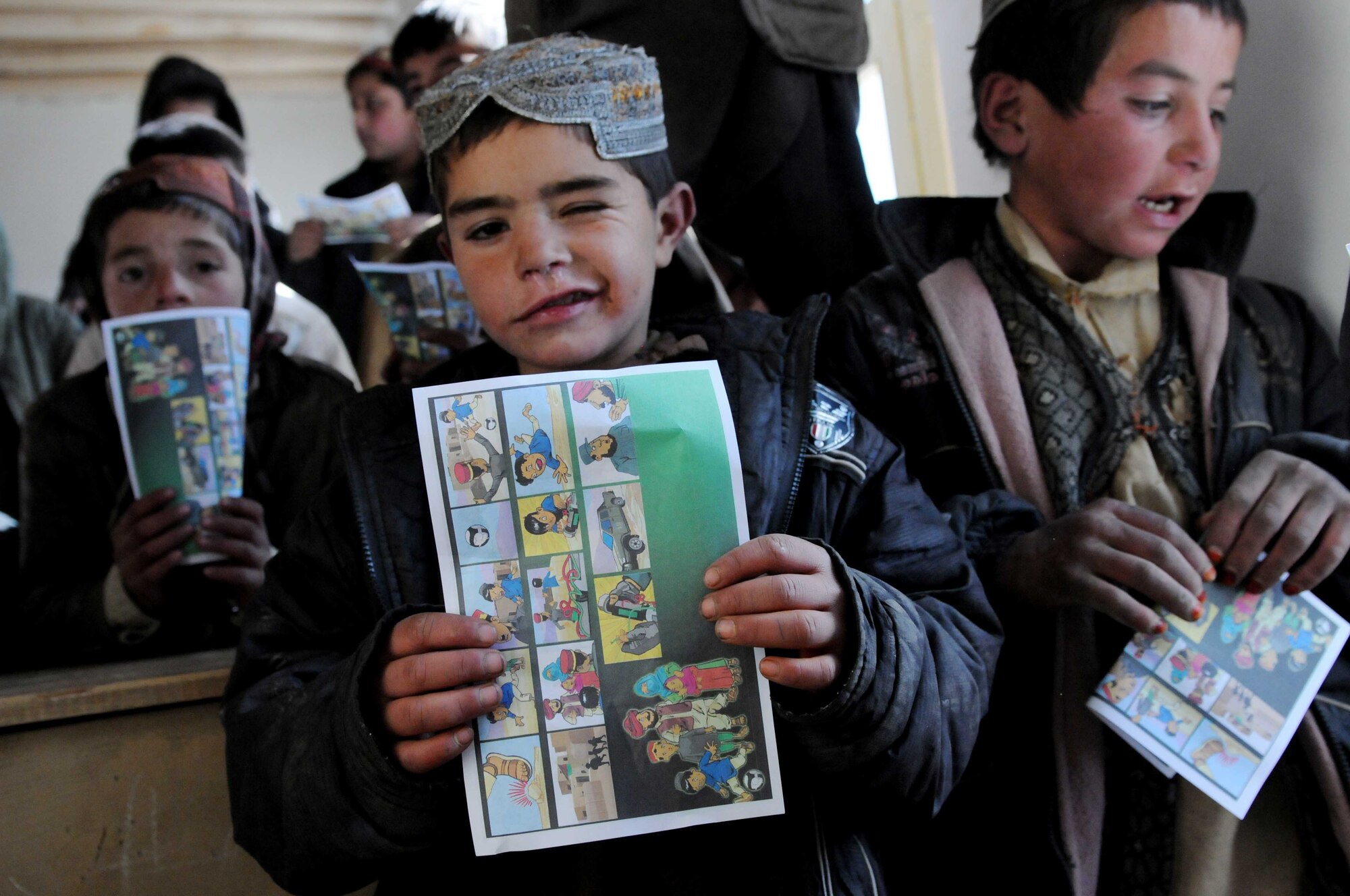 PAKTYA Province, Afghanistan—A Tandan Village student holds a Guardians of Peace handbill distributed during a village outreach mission in Paktya Province Dec. 28. The handbills provide illustrations demonstrating procedures for reporting dangerous activity to local Afghan Uniformed Police. (U.S. Air Force Photo by 1st Lt. Cammie Quinn, Paktya Provincial Reconstruction Team Public Affairs) 
