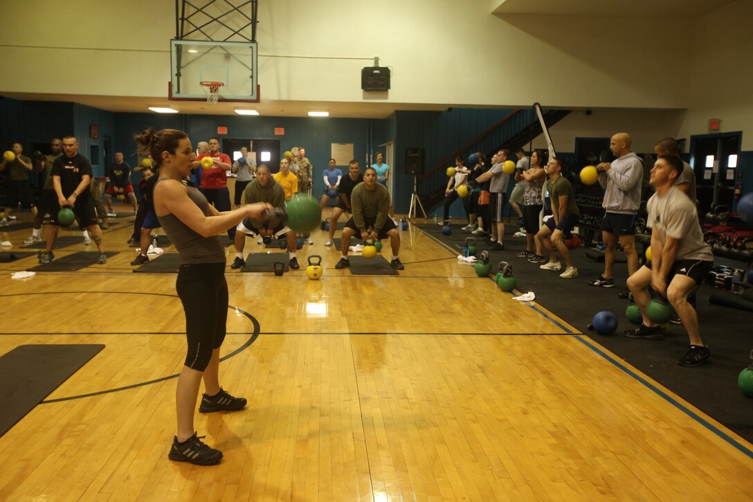 Kellie Clements, the High Intensity Tactical Training center manager leads a kettle bell class at the HITT Gym, Feb. 1. The gym is the first of its kind aboard a military base and uses ropes, sandbags, running parachutes and other exercise equipment to get service members in shape.