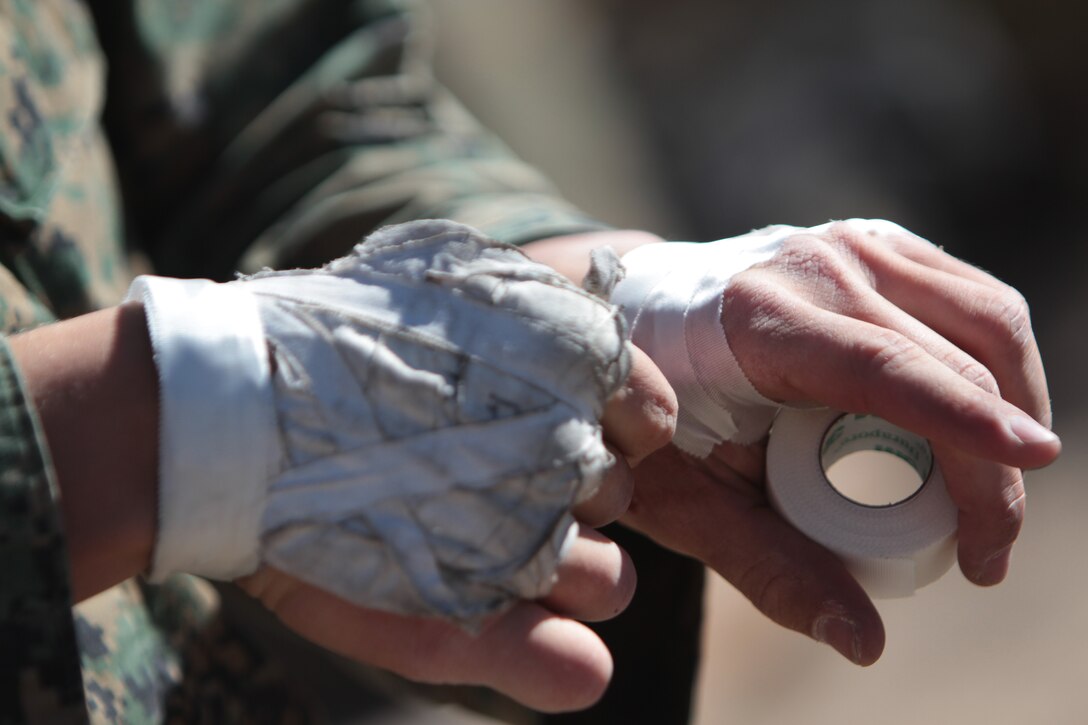 Second Lt. Keefe Murtaugh, first platoon’s commander with Company F, 2nd Battalion, 7th Marine Regiment, tapes up his battered hands before attempting another climb Feb. 1, 2011, in Joshua Tree National Park in Joshua Tree, Calif. Special Operations Training Group assault climber instructors, from Marine Corps Base Camp Pendleton, Calif., have been working with 2nd Bn., 7th Marines to train them in the ways of climbing in Joshua Tree National Park, in Joshua Tree, Calif.