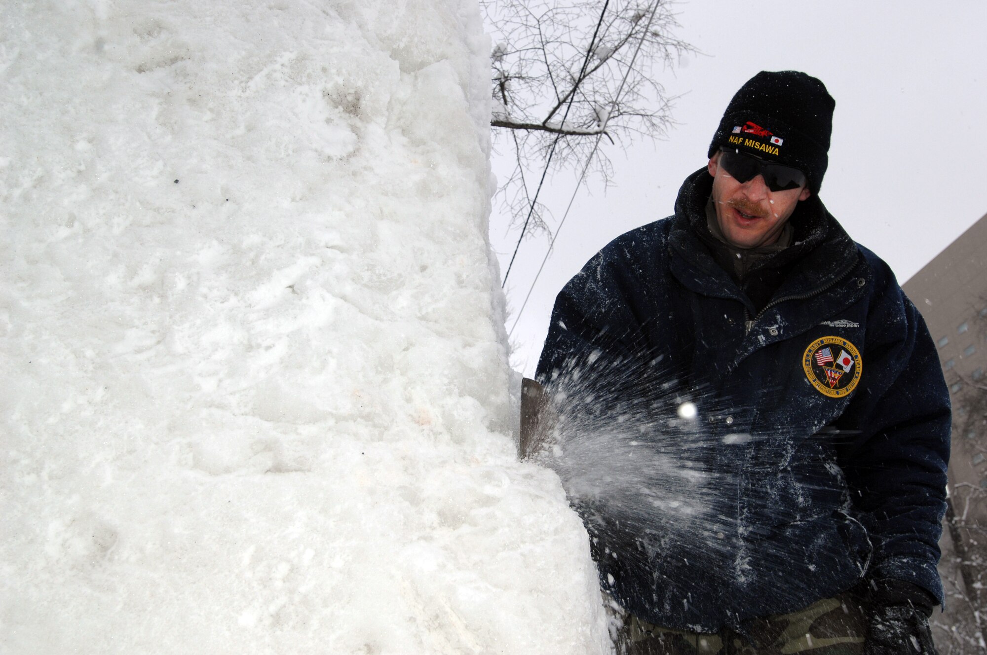 U.S. Navy Chief Builder Billy Knox, Misawa Navy Snow Team Leader, chops away at a block of snow Feb. 1, 2011, Sapporo, Japan. Knox and his five-man team will spend the week sculpting the snow into an "ice anchor," which is slated for display at the 62nd Annual Sapporo Snow Festival. Knox is stationed on board Misawa Air Base and is attached to Naval Facilities Engineering Command Far East's Public Works Department Misawa. (U.S. Navy photo by Chief Mass Communication Specialist Daniel Sanford/Released)
