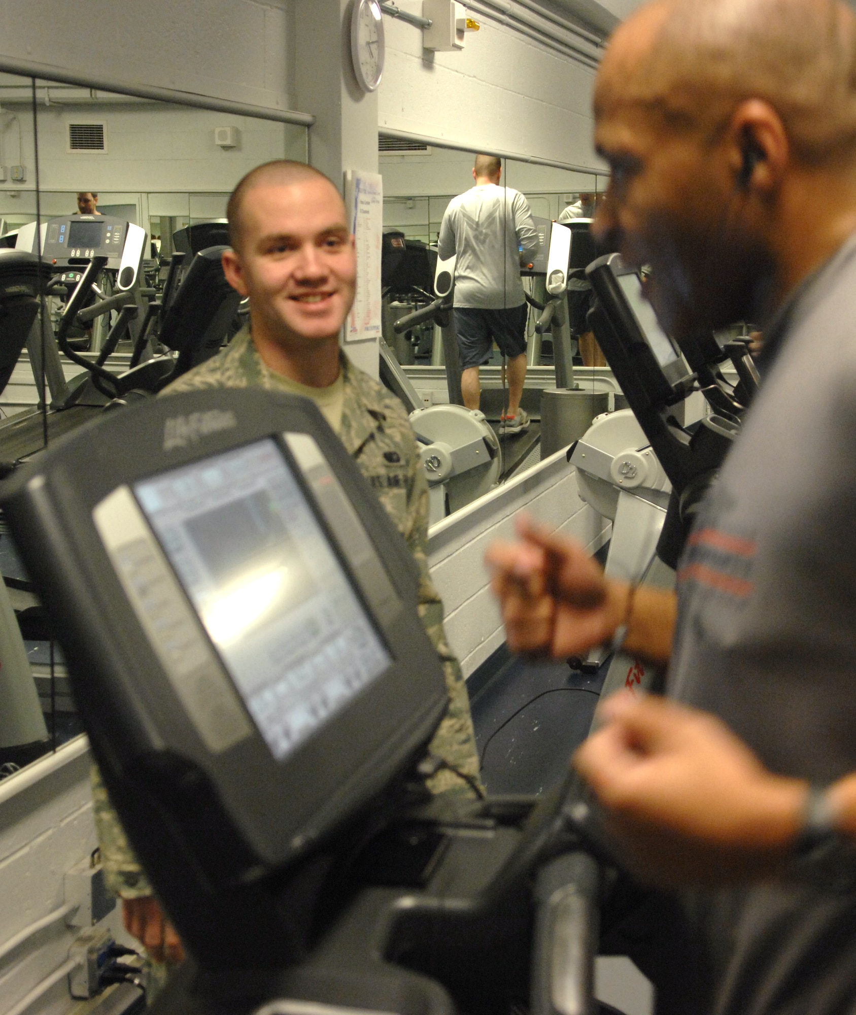 Airman 1st Class Wade Atchley assists a gym user with equipment Jan. 20, Eielson Air Force Base, Alaska. For those wanting a more personalized workout, fitness specialists are certified trainers and are qualified to assist in building an individualized program to help achieve fitness goals. Airman Atchley is assigned to the 354th Force Support Squadron. (U.S. Air Force photo/Senior Airman Rachelle Coleman)