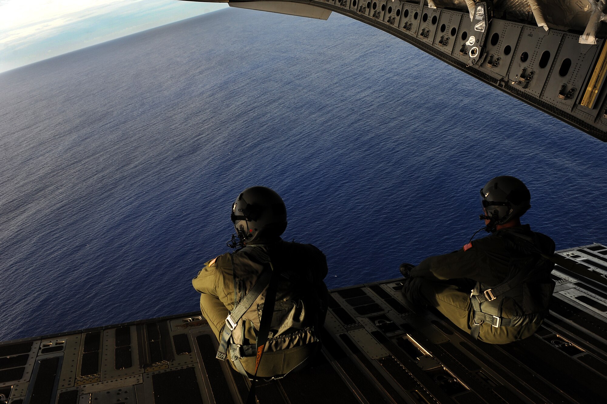 Staff Sgt. Danny Hollister and Royal Australian Air Force Flight Sgt. Dave Pyatt, 535th Airlift Squadron  airdrop loadmasters, enjoy the view after a successful airdrop deployment of Maritime Craft Aerial Delivery System Jan. 13. Airmen from Joint Base Pearl Harbor-Hickam, Hawaii, teamed with Sailors from the Naval unit to deploy the boat off the coast of Guam while merging the capabilities of the U.S. Air Force and the U.S. Navy. (U.S. Air Force photo/Staff Sgt. Mike Meares)
