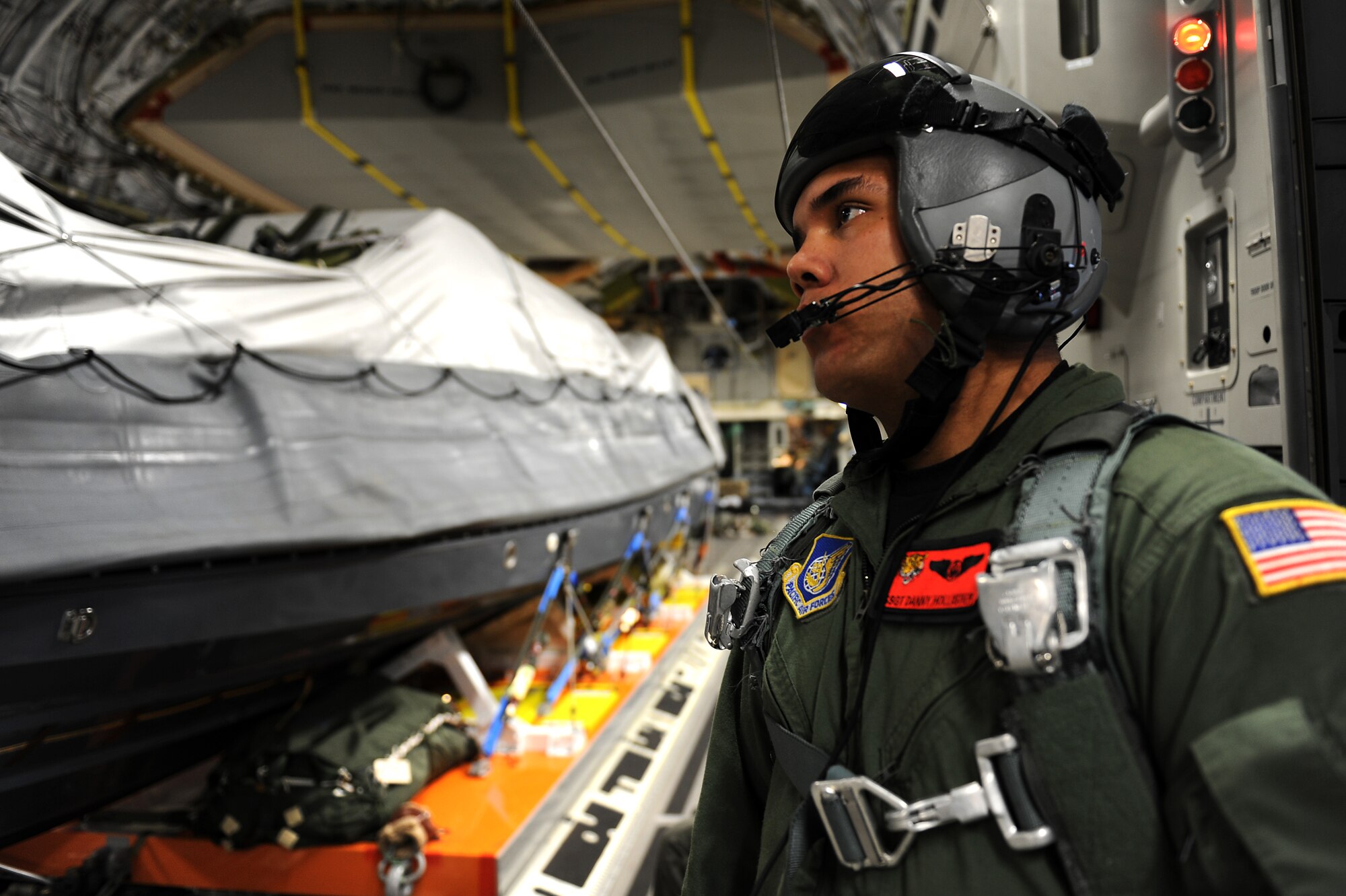 Staff Sgt. Danny Hollister, 535th Airlift Squadron C-17 Globemaster III loadmaster, prepares for an airdrop mission with a U.S. Navy Maritime Craft Aerial Delivery System Jan. 13. Airmen from Joint Base Pearl Harbor-Hickam, Hawaii, teamed with Sailors from the Naval unit to deploy the boat off the coast of Guam while merging the capabilities of the U.S. Air Force and the U.S. Navy. (U.S. Air Force photo/Staff Sgt. Mike Meares)