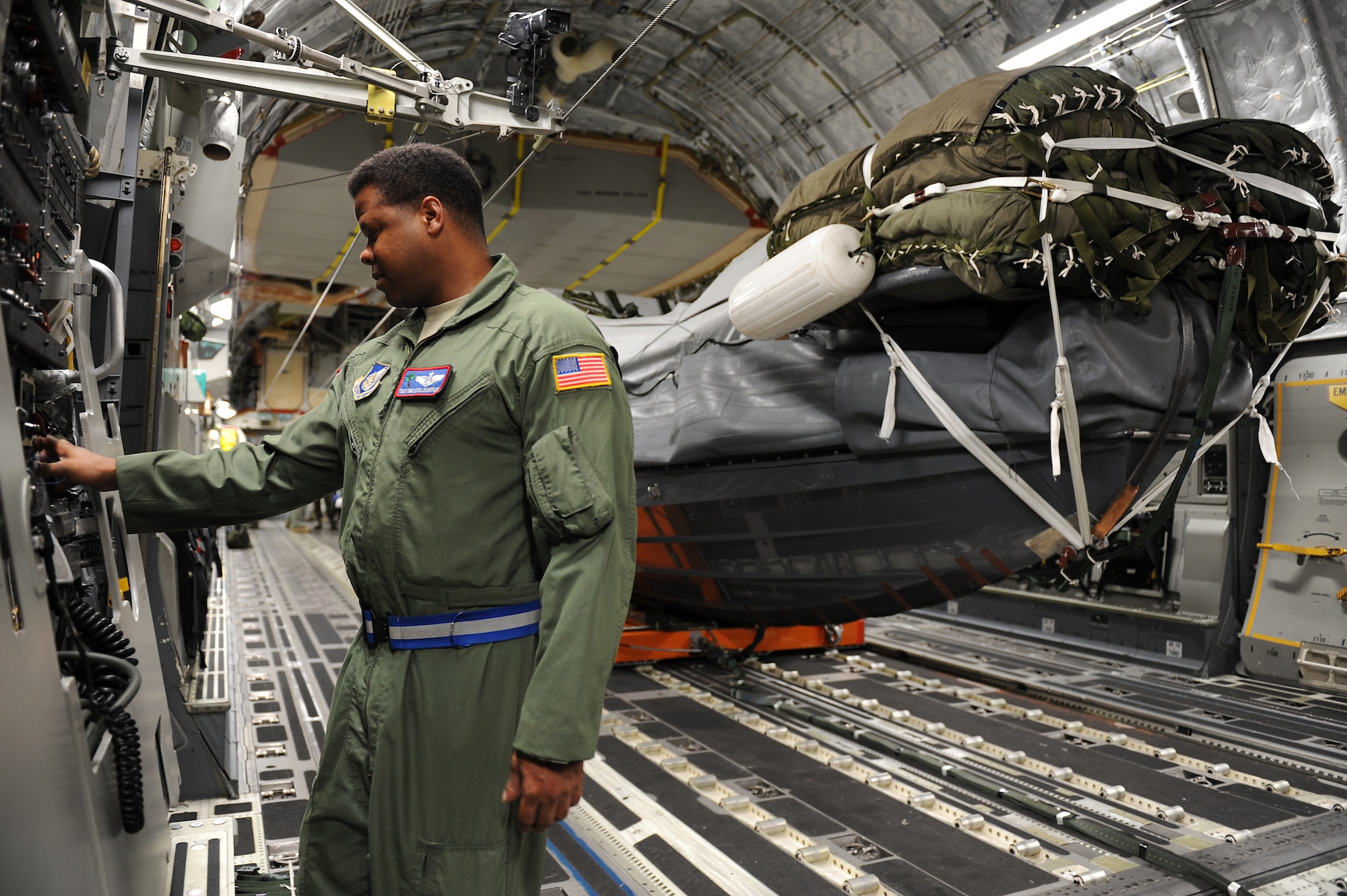 Tech. Sgt. Dre Stollenwerck, 535th Airlift Squadron loadmaster, ensures the settings on the C-17 Globemaster III are correct in preparation for an airdrop mission with a U.S. Navy Maritime Craft Aerial Delivery System Jan. 13. Airmen from Joint Base Pearl Harbor-Hickam, Hawaii, teamed with Sailors from the Naval unit to deploy the boat off the coast of Guam while merging the capabilities of the U.S. Air Force and the U.S. Navy. (U.S. Air Force photo/Staff Sgt. Mike Meares)