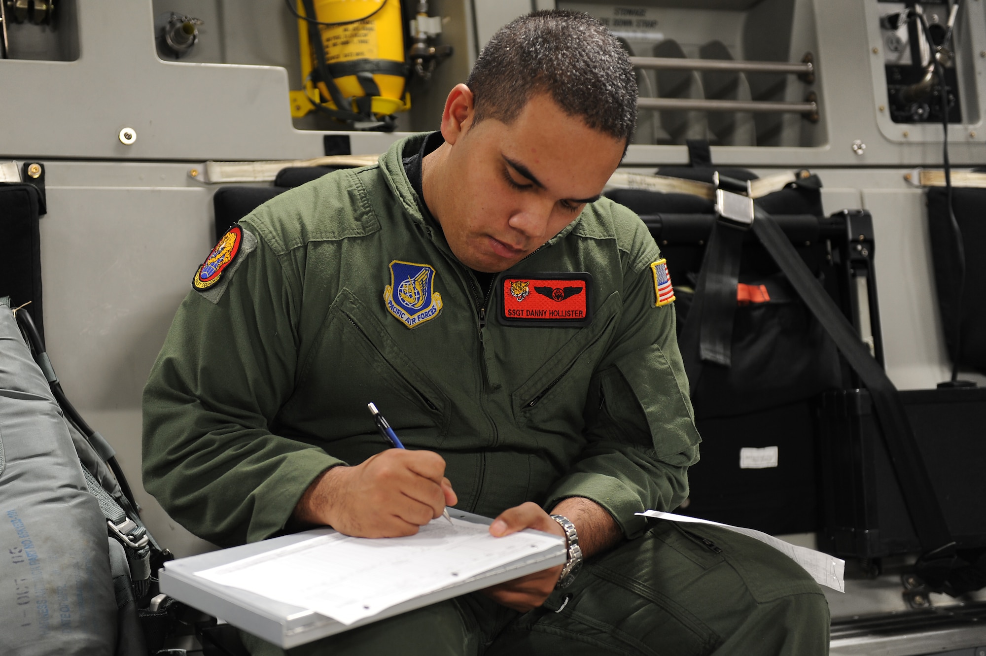 Staff Sgt. Danny Hollister, 535th Airlift Squadron C-17 Globemaster III loadmaster, goes over paperwork in preparation for an airdrop mission with a U.S. Navy Maritime Craft Aerial Delivery System Jan. 13. Airmen from Joint Base Pearl Harbor-Hickam, Hawaii, teamed with Sailors from the Naval unit to deploy the boat off the coast of Guam while merging the capabilities of the U.S. Air Force and the U.S. Navy. (U.S. Air Force photo/Staff Sgt. Mike Meares)