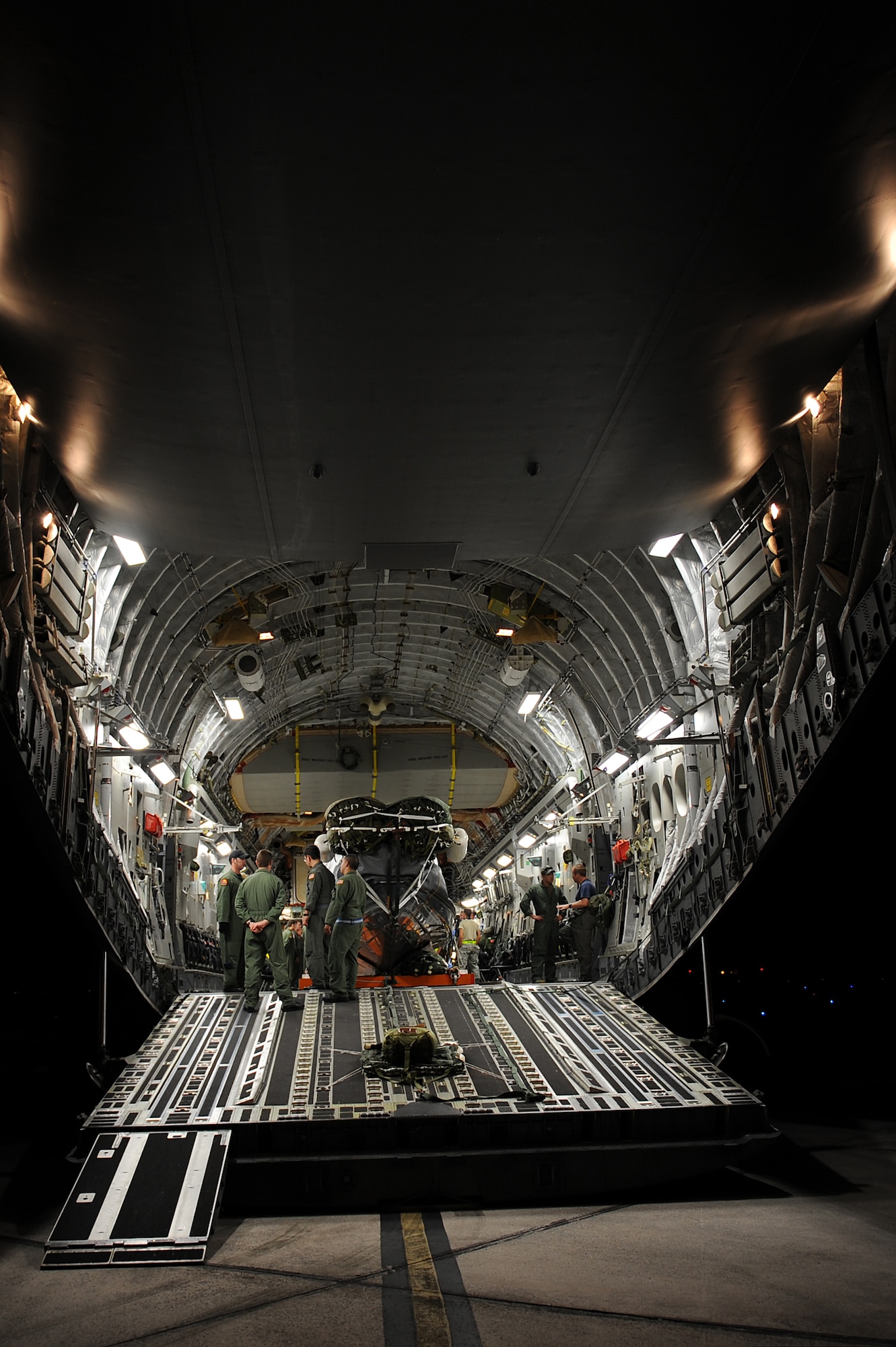 Aircrew members go over final preparations prior to take off to conduct an airdrop mission with a U.S. Navy Maritime Craft Aerial Delivery System Jan. 13. Airmen from Joint Base Pearl Harbor-Hickam, Hawaii, teamed with Sailors from the Naval unit to deploy the boat off the coast of Guam while merging the capabilities of the U.S. Air Force and the U.S. Navy. (U.S. Air Force photo/Staff Sgt. Mike Meares)