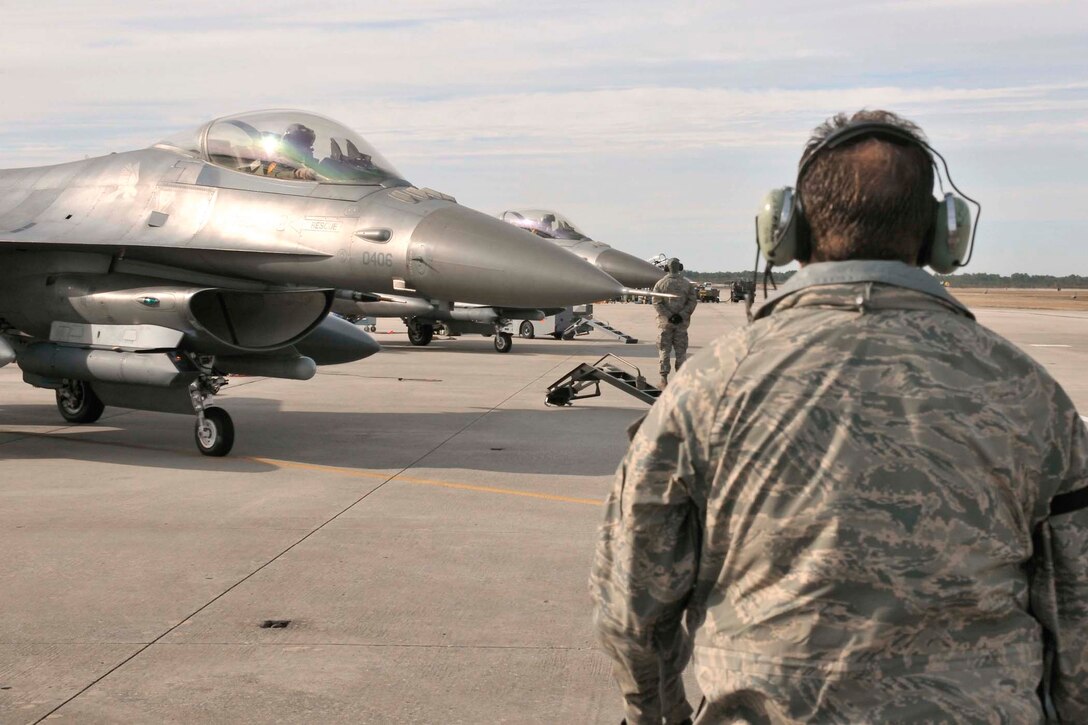Maintainers from the 179th Fighter Squadron, a subordinate unit of the 148th Fighter Wing out of Duluth, Minn., prepare to launch F-16s for a mission Jan. 27, 2011, at Tyndall Air Force Base, Fla. Airmen from the 148th FW are working with members of the 53rd Weapons Evaluation Group at Tyndall AFB for two weeks to train for their air sovereignty alert missions and to validate their newly-upgraded, Block 50 F-16s. (U.S. Air Force photo/Tech. Sgt. John Hoffmann)