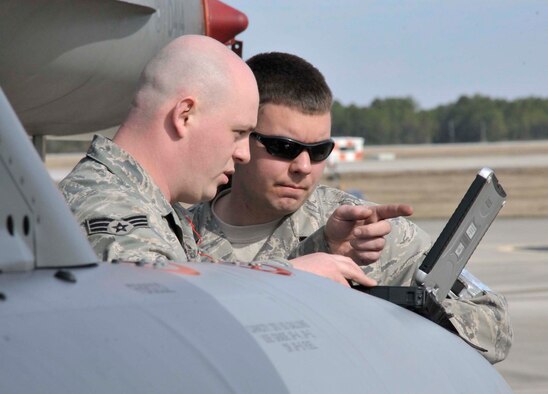 Maintainers from the 179th Fighter Squadron, a subordinate unit of the 148th Fighter Wing out of Duluth, Minn., review technical data prior to preparing an aircrew for a mission Jan. 27, 2011, at Tyndall Air Force Base, Fla. Airmen from the 148th FW are working with members of the 53rd Weapons Evaluation Group at Tyndall AFB for two weeks to train for their air sovereignty alert missions and to validate their newly-upgraded, Block 50 F-16s. (U.S. Air Force photo/Tech. Sgt. John Hoffmann)