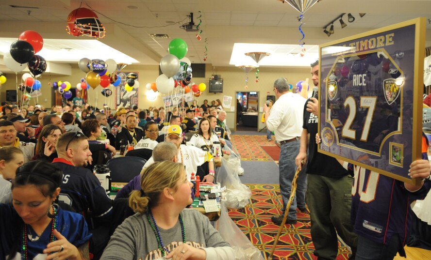 More than 500 attendees of the 2011 Super Bowl Extravaganza anxiously hold their raffle tickets in hopes of winning rare sports memorabilia at the Northern Lights Club Jan. 29. The base event brought crowds for bingo, food and fun. (U.S. Air Force photo by Staff Sgt. Suellyn Nuckolls)