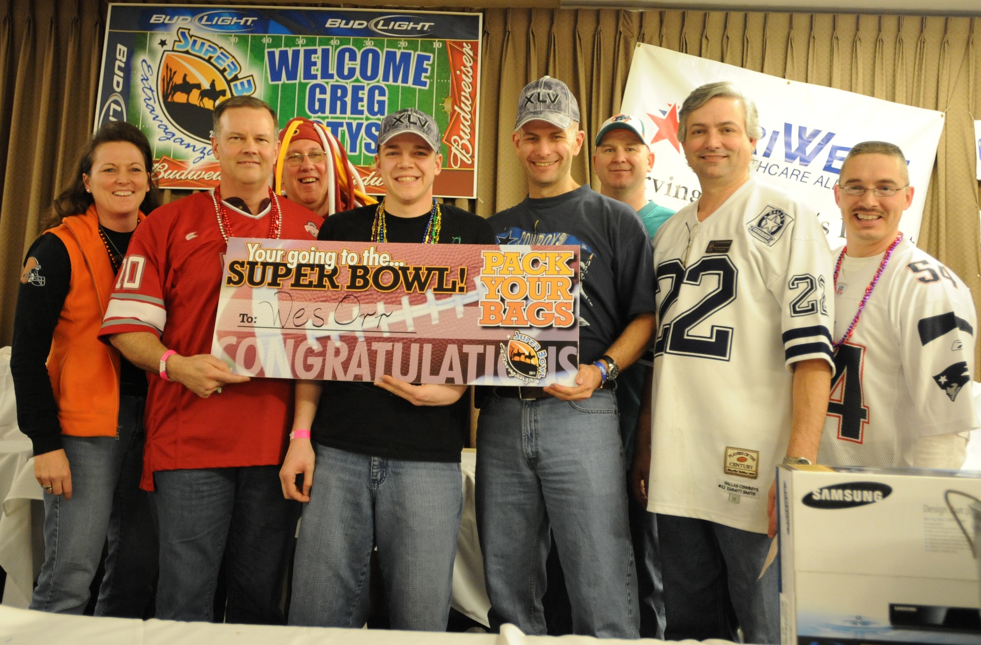2011 Super Bowl Extravaganza grand prize winner, Senior Airman Wesley Orr, 319th Communications Squadrons, poses with various Grand Forks Air Force Base leaders Jan. 29th at the Northern Lights Club. Airman Orr opted to take $5,000 rather than a trip to Super Bowl XLV in Dallas, Texas, after winning the event’s final game of bingo. (U.S. Air Force photo by Staff Sgt. Suellyn Nuckolls)