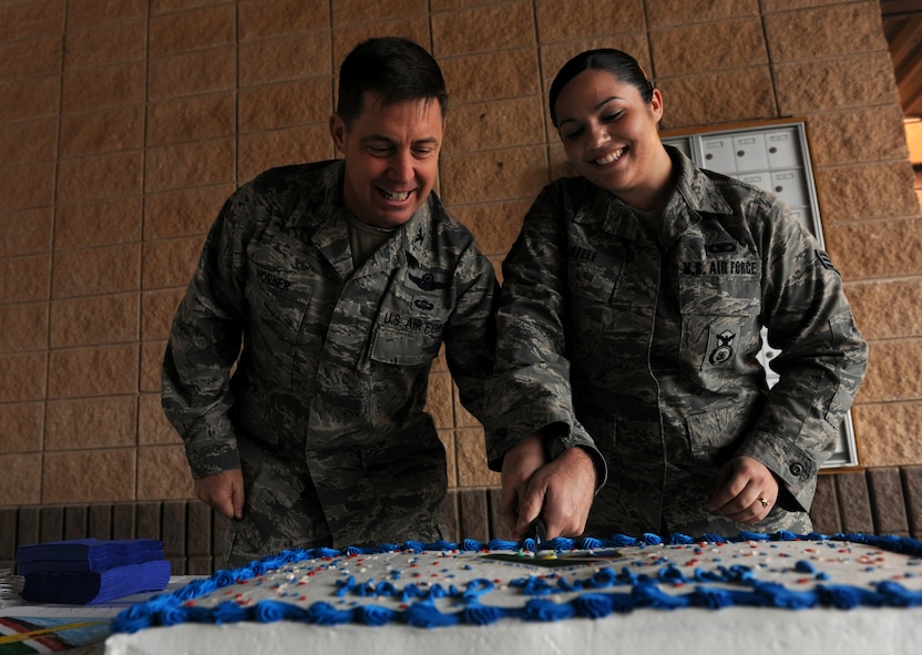 MOODY AIR FORCE BASE, Ga.-- Col. John Horner, 93rd Air Ground Operations Wing commander, and Senior Airman Amanda Letele, 93rd AGOW command chief executive, make the ceremonial first cut of the cake during the wing’s birthday celebration Feb. 1. (U.S. Air Force photo/Airman 1st Class Benjamin Wiseman)(RELEASED)