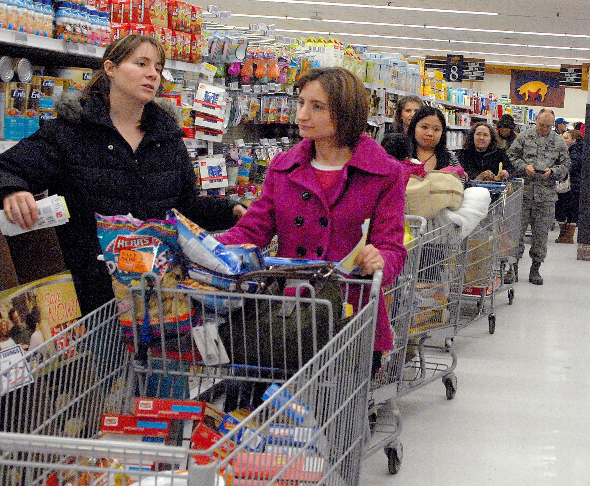Team Dover members wait in line to check out at the commissary during a Super Bowl Monday Madness Sale Jan. 31, 2011, at Dover Air Force Base, Del. The sale included specials on meat, food demonstrations and door prizes including two flat screen televisions and a Nintendo Wii.  (U.S. Air Force photo/Airman 1st Class Matthew Hubby)