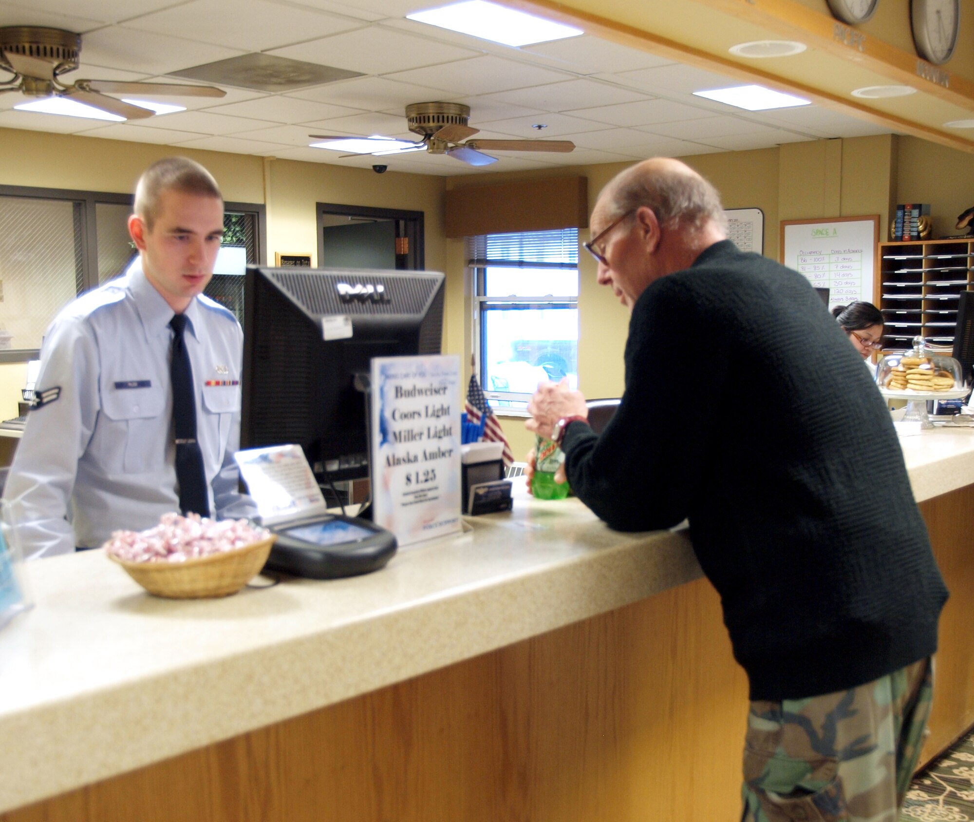 Airman 1st Class Adam Rude addresses a customer's questions at the Gold Rush Inn front desk Jan. 31, 2010, Eielson Air Force Base, Alaska.  Eielson's beautification project enhanced the guest service window by replacing countertops and carpeting in the lobby area.  Airman Rude is assigned to the 354th Force Support Squadron as a guest services representative.  (Courtesy Photo)