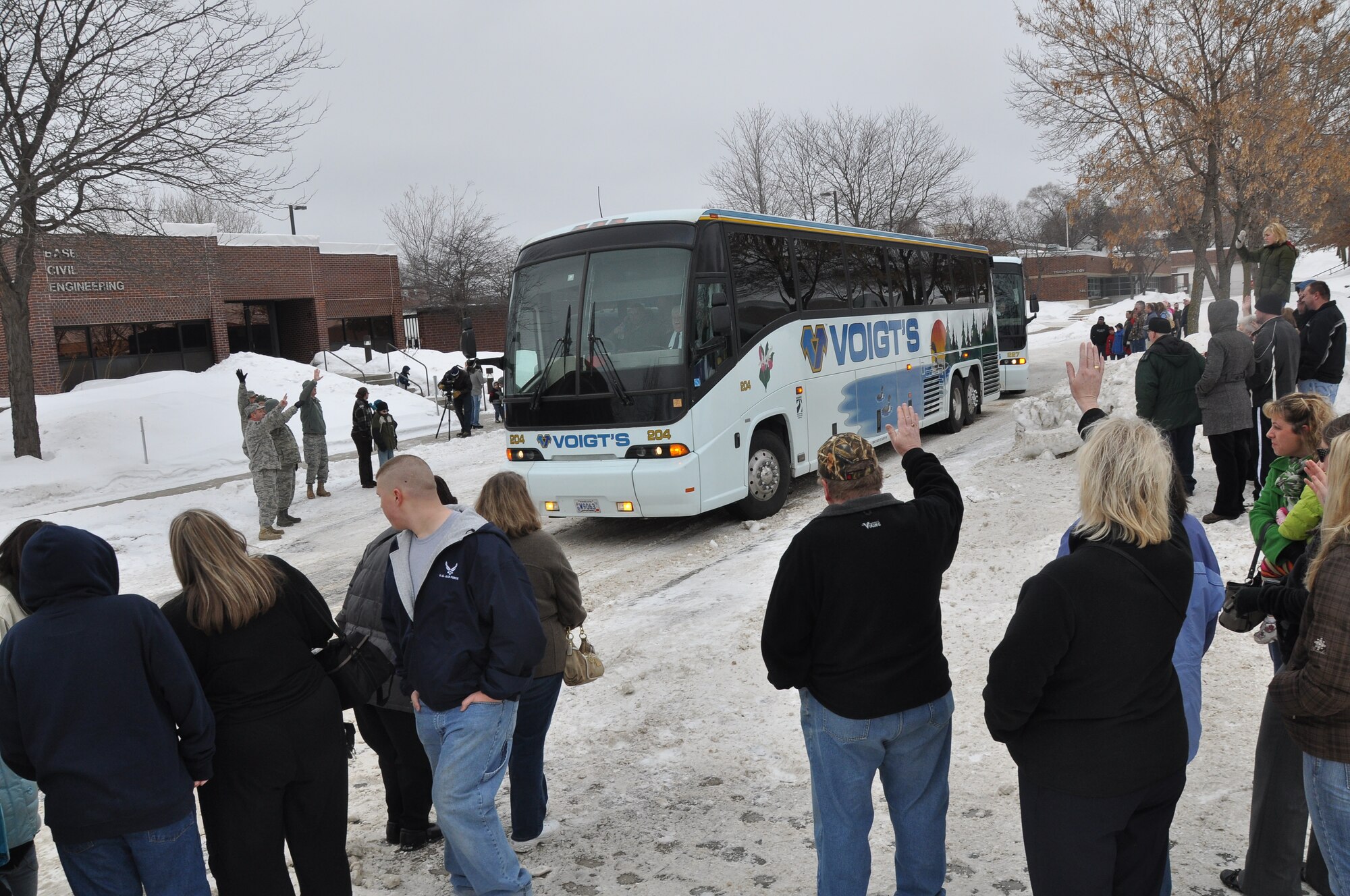 Family and friends wave goodbye as a bus carries 934th Civil Engineers to Ft. McCoy for combat skills training before leaving for Afghanistan. (Air Force Photo/Tech. Sgt. Bob Sommer) 