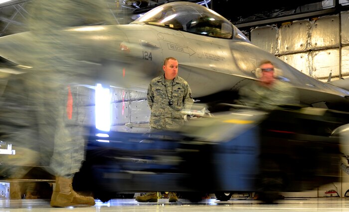 U.S. Air Force Tech. Sgt. Robert Tracy, 388th Maintenance Group, judges the Load Crew of the Year (LCOY) competition on Dec. 17, 2010 on Hill Air Base, Utah. LCOY gives three maintenance squadrons on Hill AFB a chance to showcase their efficiency against each other while being judged for accuracy and speed.(U.S. Air Force photo by Airman Allen Stokes)