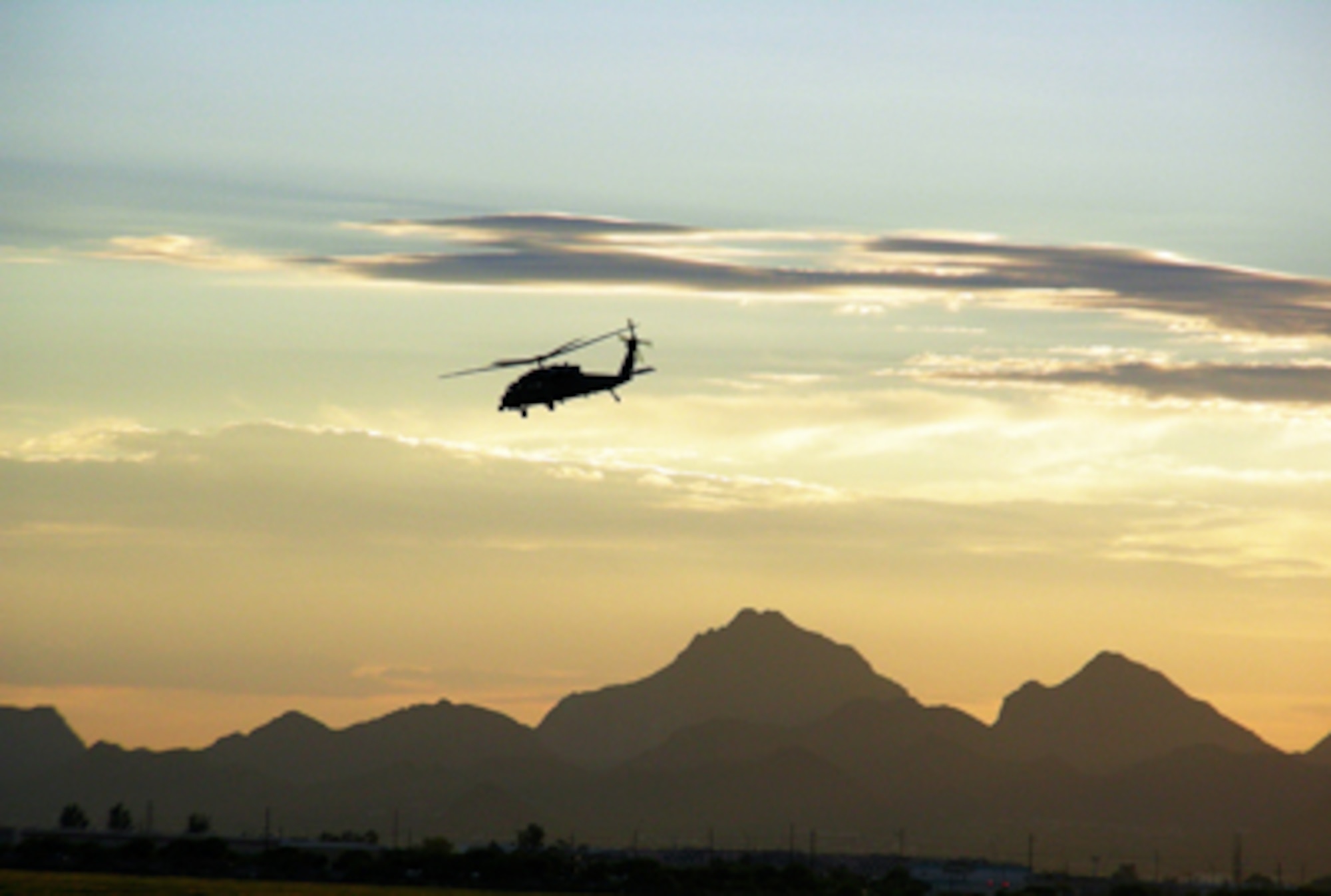 A 920th Rescue Wing HH-60G Pave Hawk helicopter pierces the desert sky over the southern-Arizona mountains as part of two-weeks of high-altitude training as pilots and aircrews from the 920th Rescue Wing here trained July 12 through 25, 2008, at Davis-Monthan Air Force Base, Ariz. Members of the 943rd Rescue Group here responded to a Department of Public Safety helicopter crash recently. As an Air Force Reserve Command unit, the 943rd RQG is currently under the control of the 920th Rescue Wing, Patrick Air Force Base, FL., and is the only Reserve rescue unit in the Southwestern United States. (U.S. Air Force photo/Capt. Cathleen Snow)