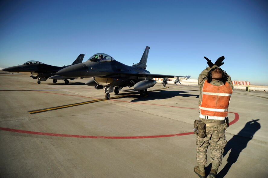 An F-16 crew chief taxis aircraft into position prior to takeoff for its final inspection Dec. 15, 2010 on Hill Air Force Base, Utah. Hill AFB performs multiple launches a day to ensure each jet is fully functional and deployable ready. (U.S. Air Force photo by Airman Allen Stokes)