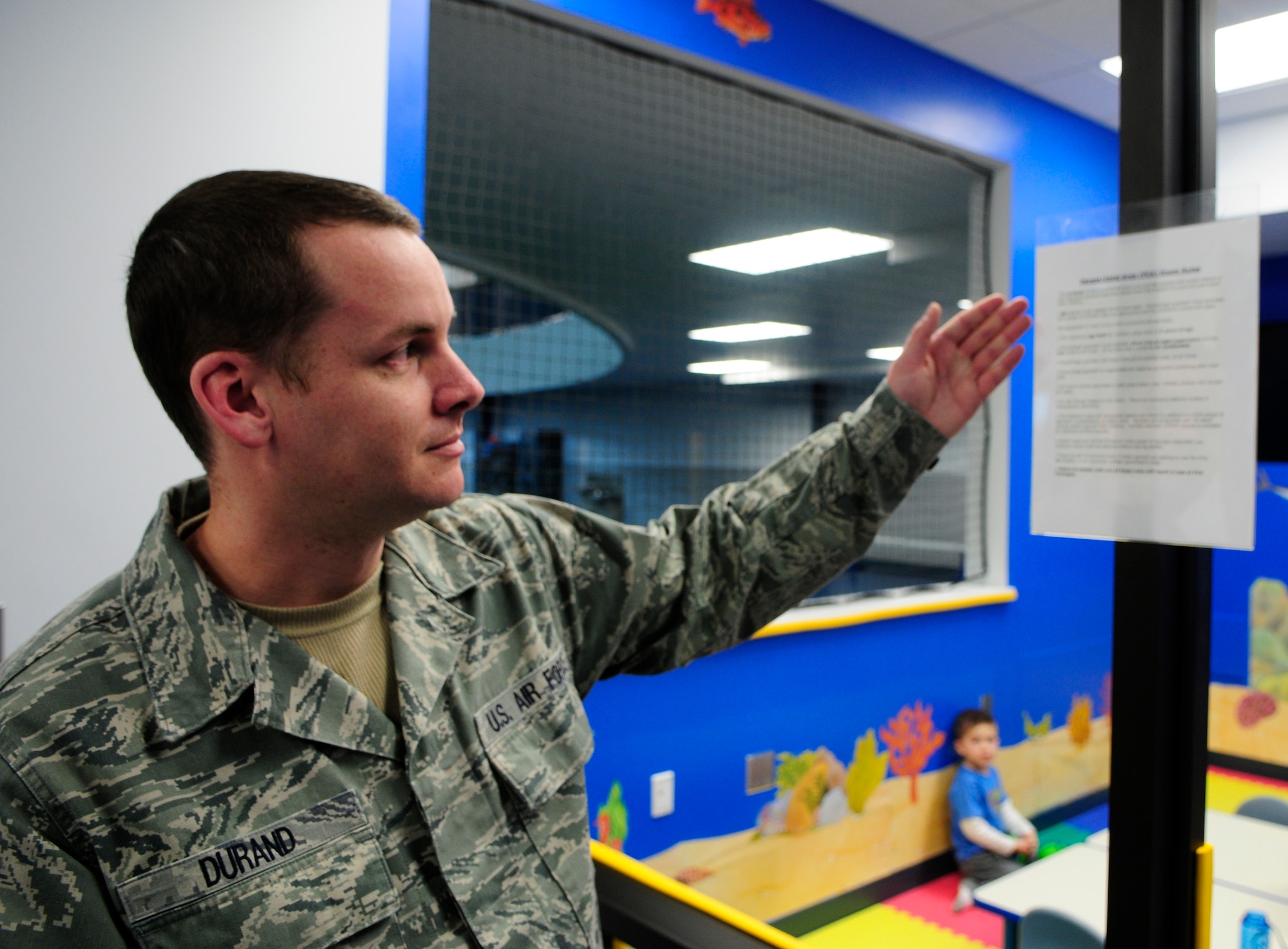 Tech. Sgt. Christopher Durand explains ground rules for the Baker Field House's new parent-child area Jan. 31, 2010, Eielson Air Force Base, Alaska. The new area has cardio machines and a small weight area where parents can work out while their children play in a child-friendly area just a few feet away. Sergeant Durand is a shift supervisor assigned to the 354th Force Support Squadron. (U.S. Air Force photo by/Airman 1st Class Yash Rojas)