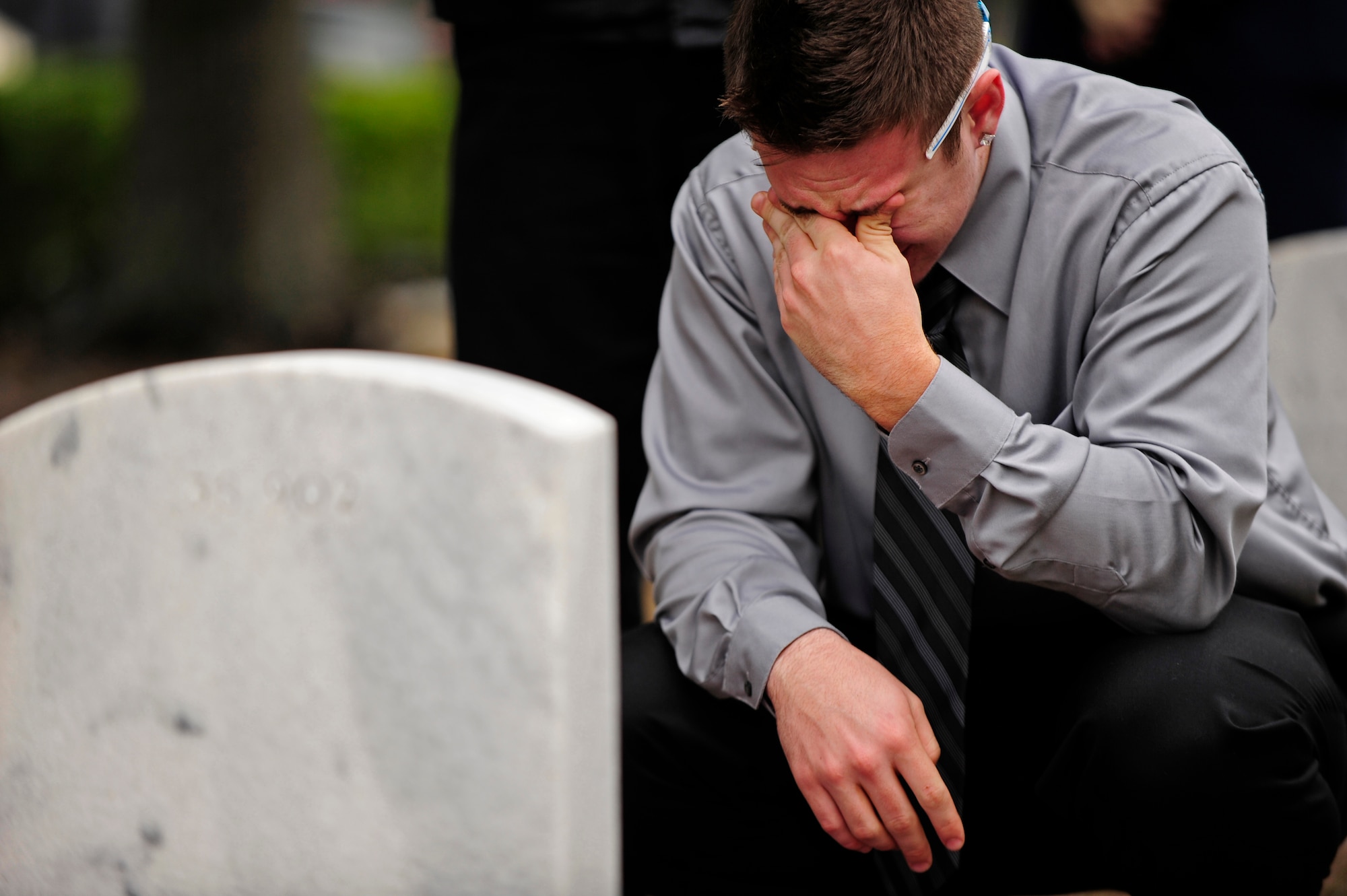 Robert K. Hodges Jr. mourns the death of his father, U.S. Air Force Tech. Sgt. Robert K. Hodges Sr., after a wreath-laying ceremony Jan. 31, 2011, at the Barrancas National Cemetery, Pensacola Naval Air Station, Fla. The ceremony marked the 20th anniversary of when 14 Airmen lost their lives when Spirit 03, an AC-130H Spectre gunship, was shot down by enemy fire in support of Operation Desert Storm Jan. 31, 1991. (U.S. Air Force photo by Staff Sgt. Julianne M. Showalter/Released)