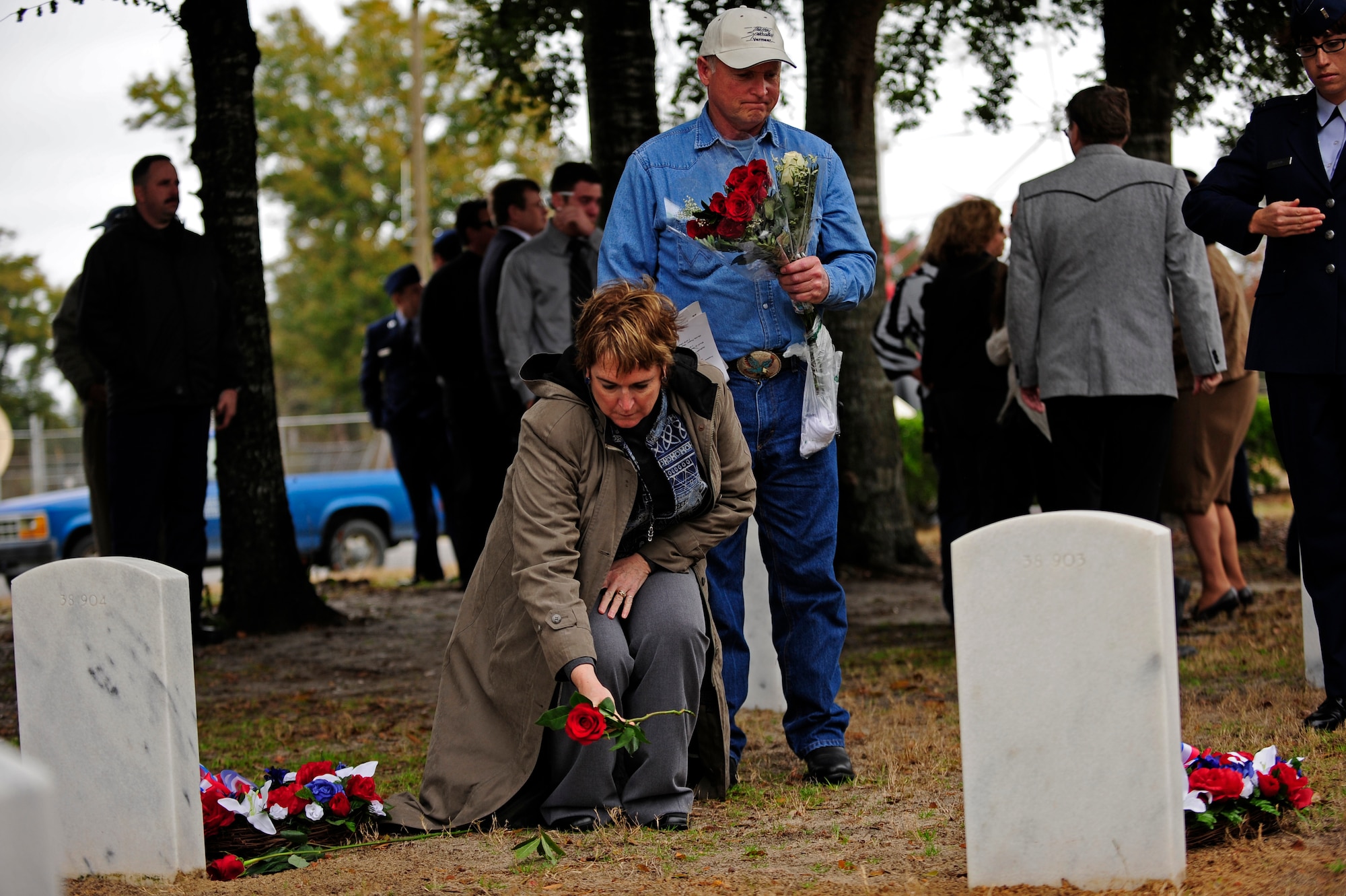 Family members of the Spirit 03 crew lay roses on the graves following a wreath-laying ceremony Jan. 31, 2011, at the Barrancas National Cemetery, Pensacola Naval Air Station, Fla. The ceremony marked the 20th anniversary of when 14 Airmen lost their lives when Spirit 03, an AC-130H Spectre gunship, was shot down by enemy fire in support of Operation Desert Storm Jan. 31, 1991. (U.S. Air Force photo by Staff Sgt. Julianne M. Showalter/Released)