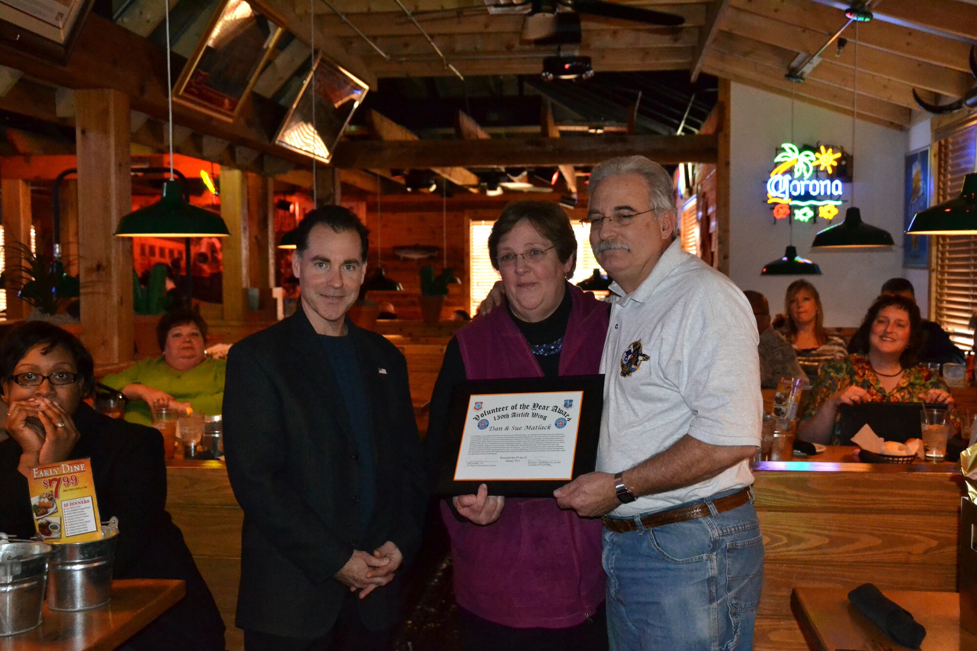 Dan and Sue Matlack are presented with the volunteer of the year award by Colonel Mike McEnulty, commander, 139th Airlift Wing, Mo. Air National Guard, on January 8, 2011. This and other volunteer presentations were made at Texas Road House, restaurant in St. Joseph, Mo.