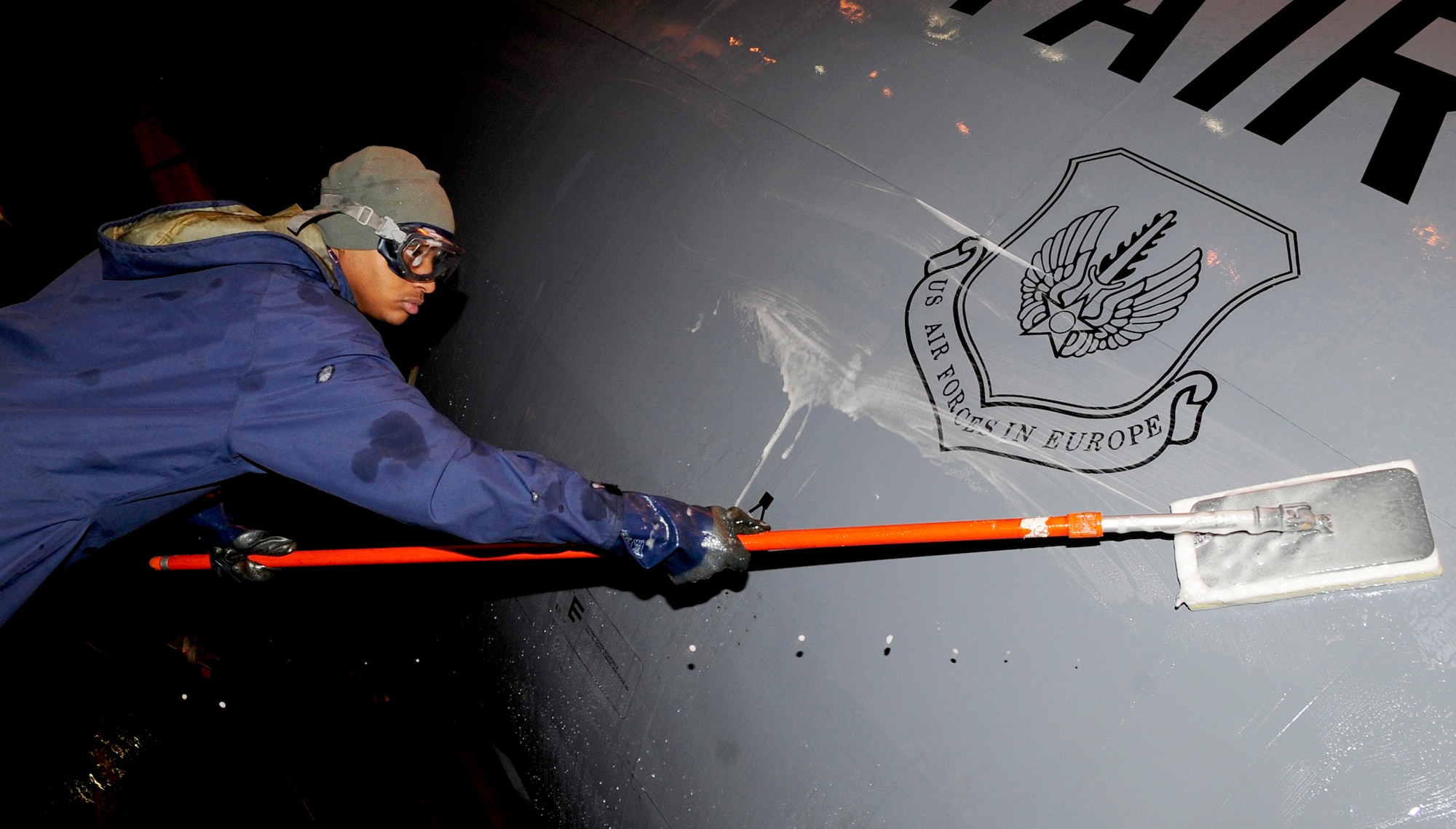 RAF MILDENHALL, England -- Staff Sgt. Jamie Harrington, 100th Aircraft Maintenance Squadron aerospace maintenance journeyman, washes a KC-135 Stratotanker during a washrack process here Jan. 31, 2011. The KC-135 is sent through the process so that it can be cleaned and lubricated to prevent corrosion and deterioration. (U.S. Air Force photo/Senior Airman Ethan Morgan)