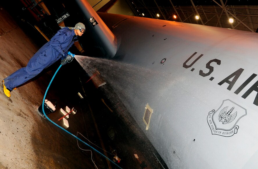 RAF MILDENHALL, England -- Staff Sgt. Jamie Harrington, 100th Aircraft Maintenance Squadron aerospace maintenance journeyman, sprays down the side of a KC-135 Stratotanker while preparing to wash it during a washrack process here Jan. 31, 2011.  The KC-135 is pre-soaked as the first step in the washing process to knock off excess debris that could potentially damage the plane's surface. (U.S. Air Force photo/Senior Airman Ethan Morgan)