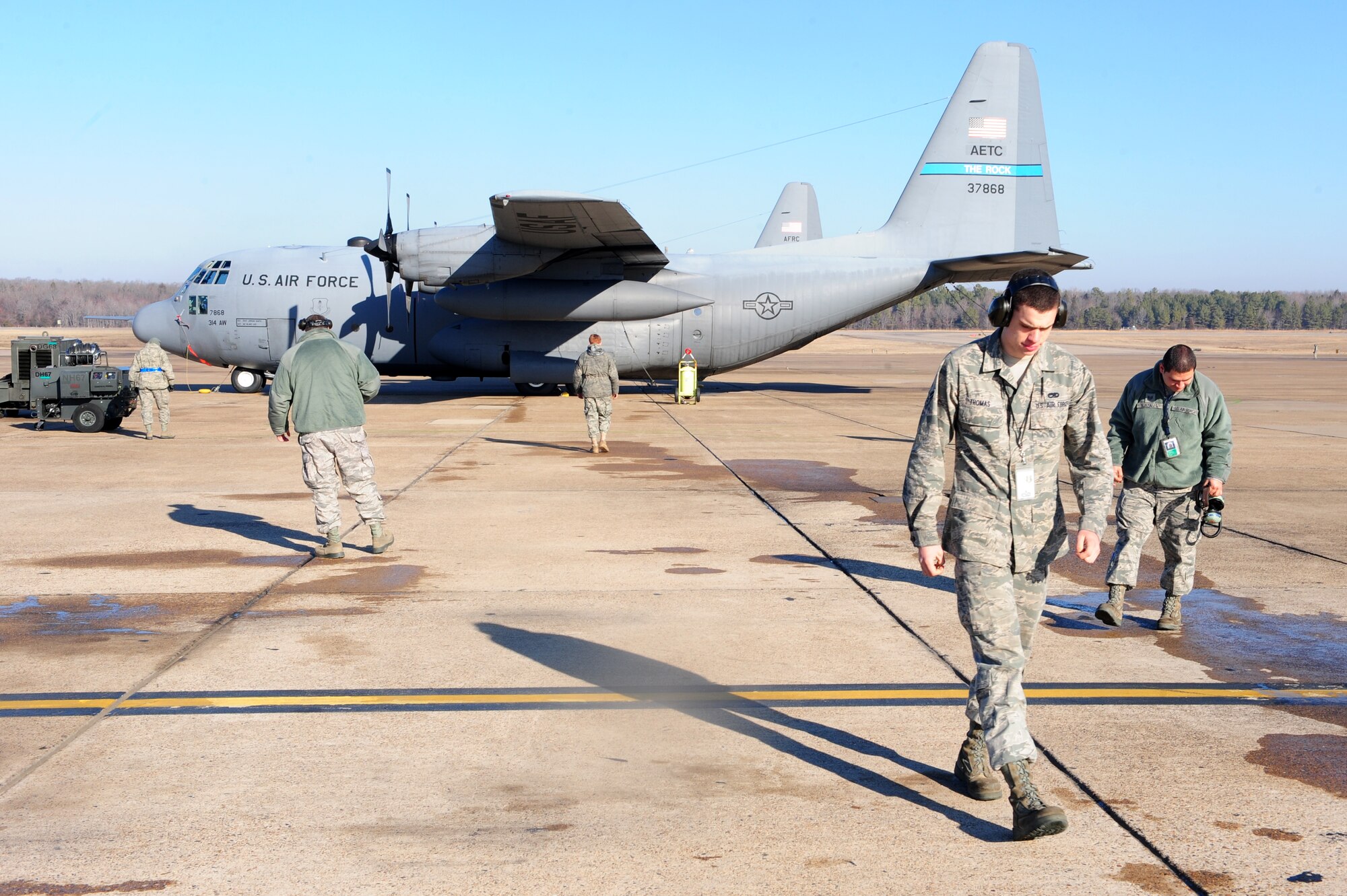 314th Aircraft Maintenance Squadron members perform a foreign object debris walk during a unit compliance inspection Jan. 26, 2011, at Little Rock Air Force Base, Ark.  A FOD walk is a way of removing any foreign object or debris from a flightline to prevent potential damage to an aircraft. (Photo by U.S. Air Force Senior Airman Jim Araos)