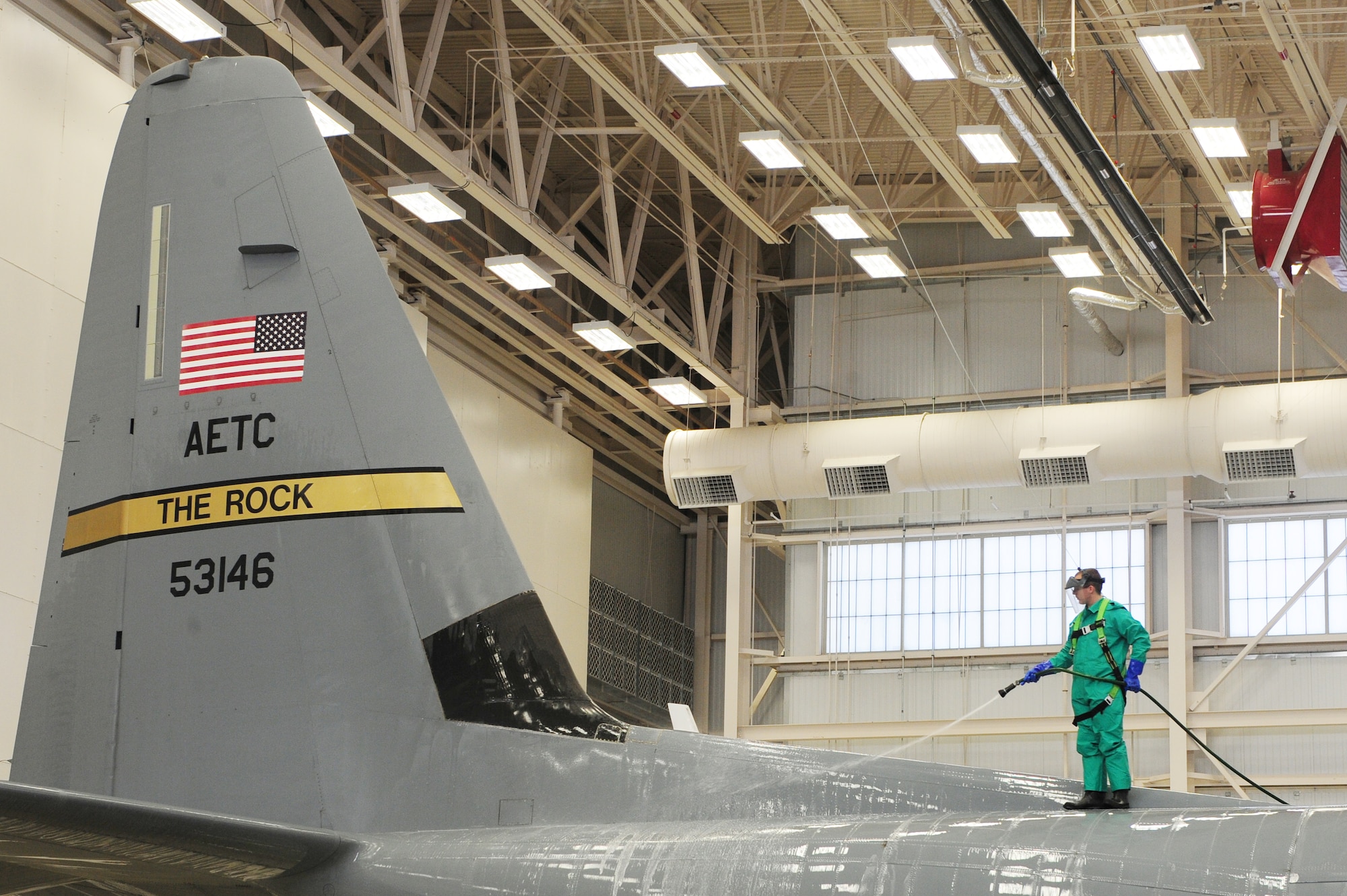 Senior Airman Jason Hughes, a 314th Aircraft Maintenance Squadron aircraft electrician, washes the tail of a C-130J Jan. 26, 2011, at Little Rock Air Force Base, Ark. Each C-130 is washed once every 150 days.  (Photo by U.S. Air Force Senior Airman Jim Araos)