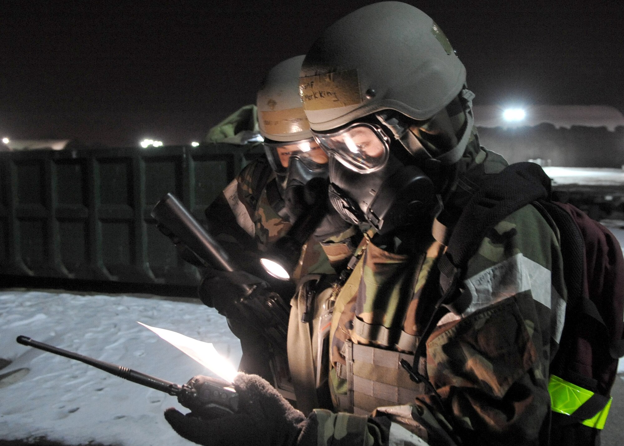 Airmen read instructions while conducting a post-attack reconnaissance sweep Jan. 28, 2011, at Osan Air Base, South Korea, as part of Beverly Bulldog 11-01, an operational readiness exercise. Post-attack reconnaissance sweeps are conducted after an attack to survey the area for contamination, unidentified explosive ordnance, casualties or suspicious activity. (U.S. Air Force photo/Senior Airman Evelyn Chavez)