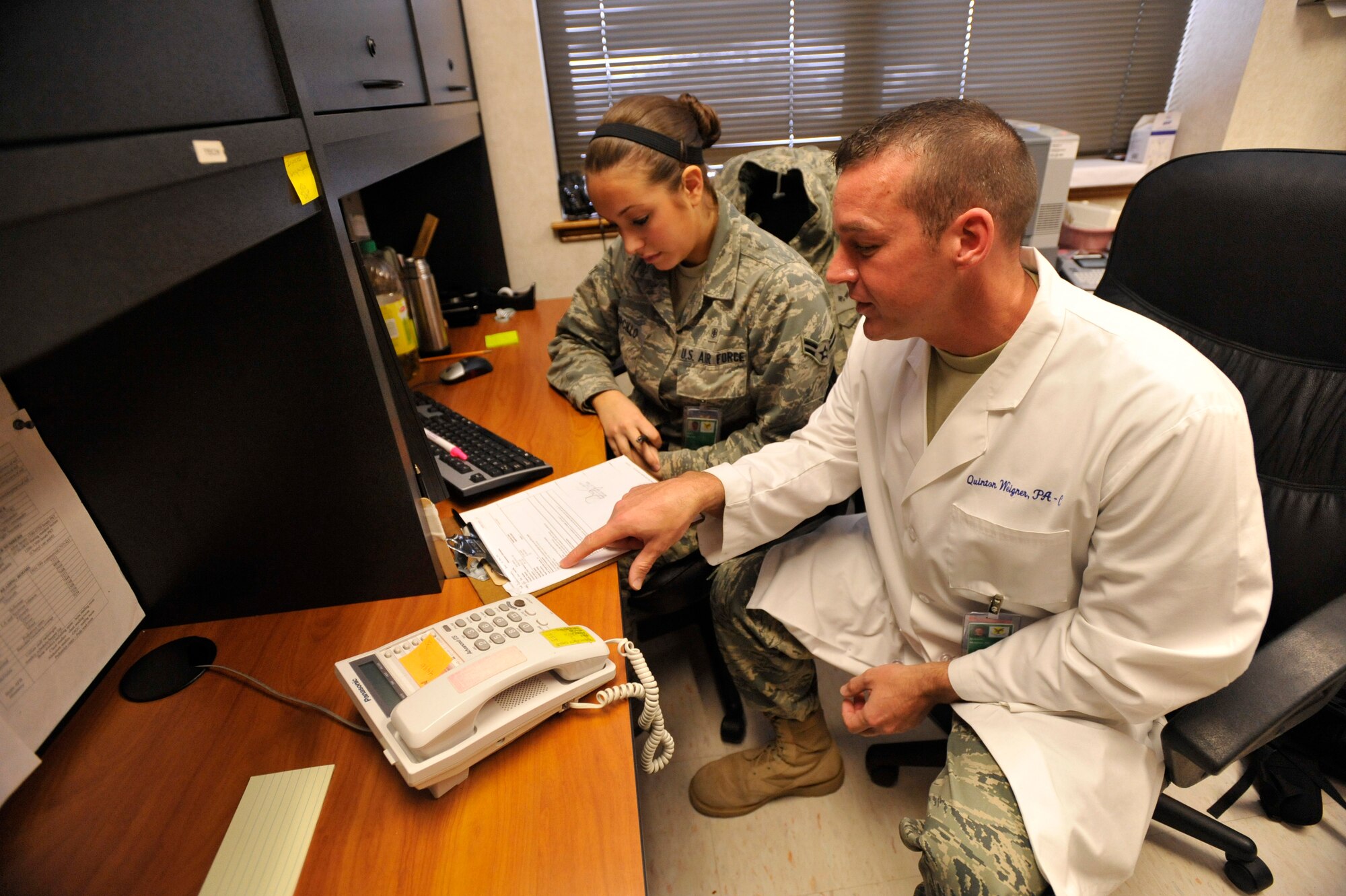 Captain Weigner gives advice to Airman 1st Class Juliet Corcillo.

