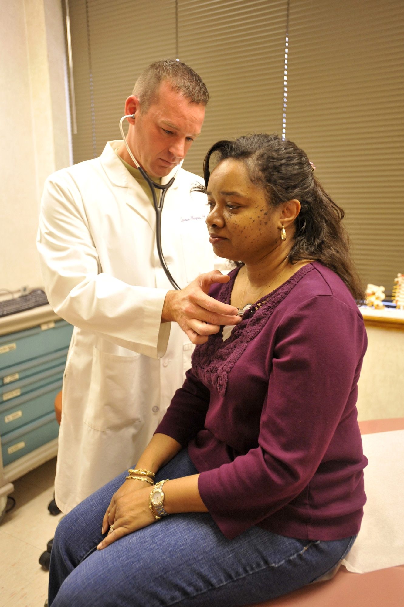 Capt. Quinton Weigner, 436th Medical Squadron physician's assistant, checks the breathing of patient Denise Freeman at the Base Hospital on Dover Air Force Base, Del. Jan. 28, 2011. Captain Weigner is a prior-service Airman who was a 14-year master sergeant before switching to the medical career field. 

