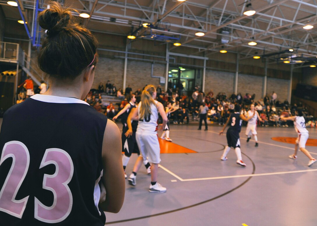 ROYAL AIR FORCE LAKENHEATH, England -- Katie Claunch, a member of the Lakenheath High School girl's basketball team - the Lakenheath Lancers - wears a jersey with pink numbers and lettering in support of breast cancer awareness during a game against the International School of Brussels Raiders on Jan. 22. (U.S. Air Force photo/Senior Airman Tiffany M. Deuel)