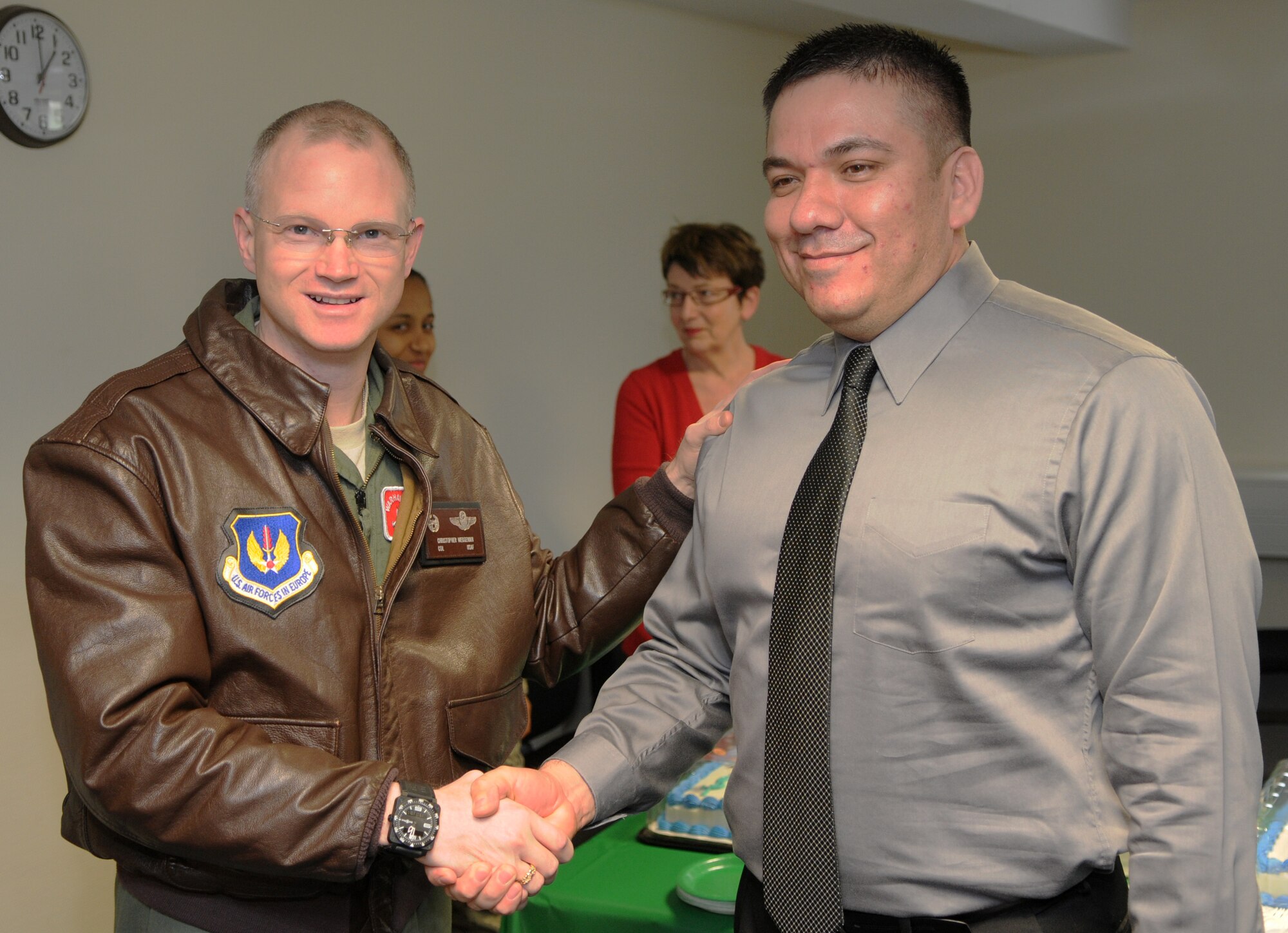 SPANGDAHLEM AIR BASE, Germany – Col. Christopher Weggeman, 52nd Fighter Wing commander, thanks Juan Carrizales, Internal Revenue Service senior tax consultant from San Antonio, Texas, Jan. 28 for training volunteers who will help Saber Airmen with their tax returns at the 52nd FW Tax Center. The 52nd FW Tax Center will be open Feb. 1 – June 15 and is located on the first floor of Bldg. 125. (U.S. Air Force photo/Airman 1st Class Matthew B. Fredericks)