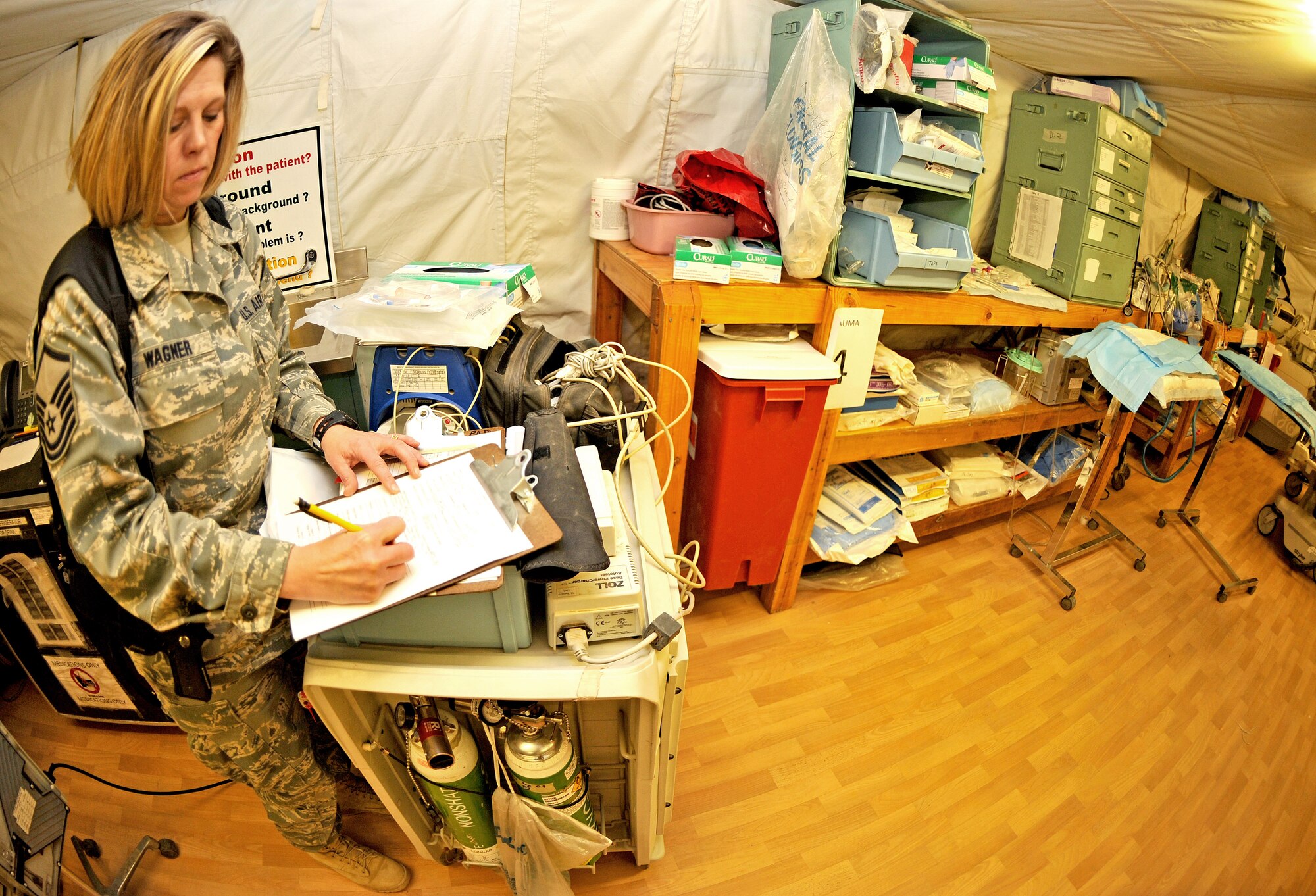 Master Sgt. Apryl Wagner, 467th Casualty Liaison Team non-commissioned officer in charge, fills out a CLT support form with a patient’s information inside the combat support hospital Jan. 26, 2011, on Contingency Operating Base Speicher, Iraq. (U.S. Air Force photo by Senior Airman Andrew Lee/Released)