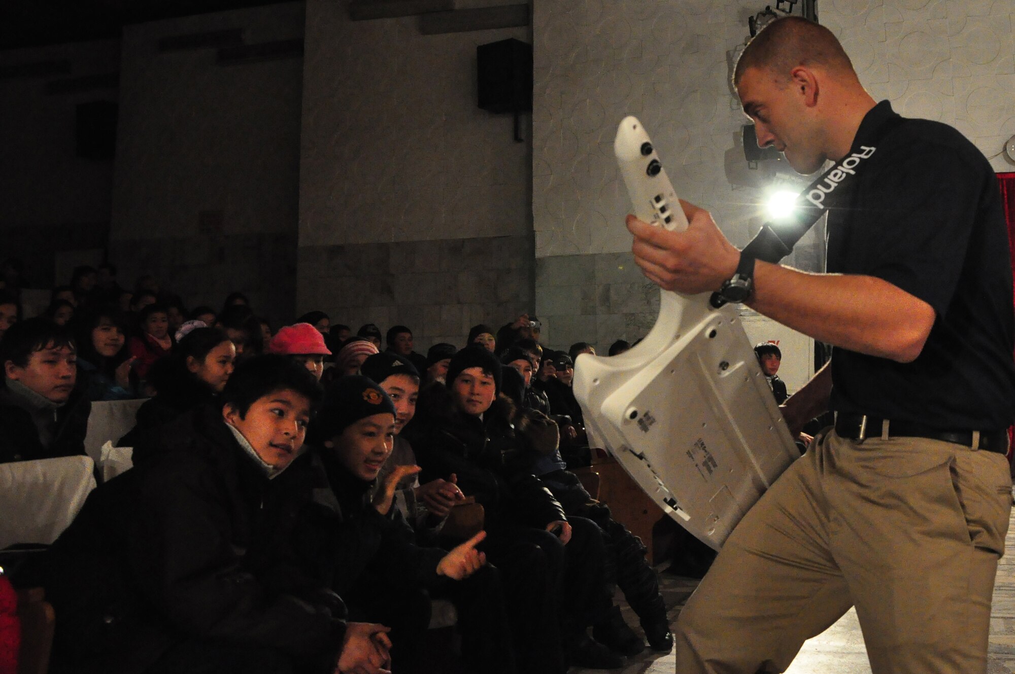 Senior Airman Adam Braatz demonstrates his prowess with the keytar during a U.S. Air Forces Central band "Starlifter" concert at the "Alyi Parus" House of Culture, Kant, Kyrgyzstan, Jan. 31. Starlifter, based out of Scott Air Force Base, Ill., is currently deployed as the U.S. Air Forces Central Expeditionary Band. These dynamic musicians travel throughout the CENTAF Area of Responsibility promoting troop morale, diplomacy and outreach to host nation communities. (U.S. Air Force photo/ Master Sgt. Daniel H. Nathaniel III) 