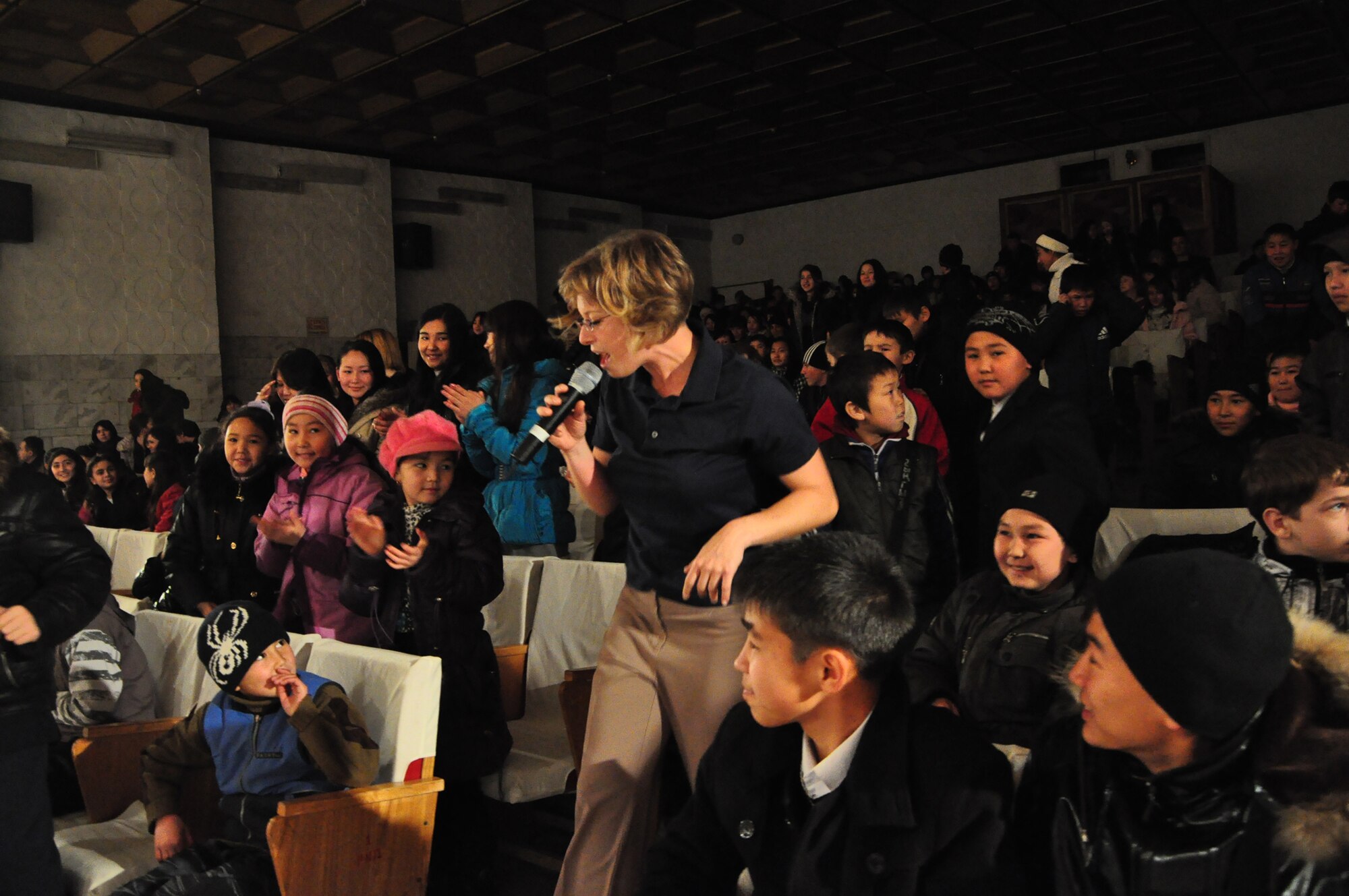 Airman 1st Class Carmen Emborski works the audience during a U.S. Air Forces Central band "Starlifter" concert at the "Alyi Parus" House of Culture, Kant, Kyrgyzstan, Jan. 31. Starlifter, based out of Scott Air Force Base, Ill., is currently deployed as the U.S. Air Forces Central Expeditionary Band. These dynamic musicians travel throughout the CENTAF Area of Responsibility promoting troop morale, diplomacy and outreach to host nation communities. (U.S. Air Force photo/ Master Sgt. Daniel H. Nathaniel III) 