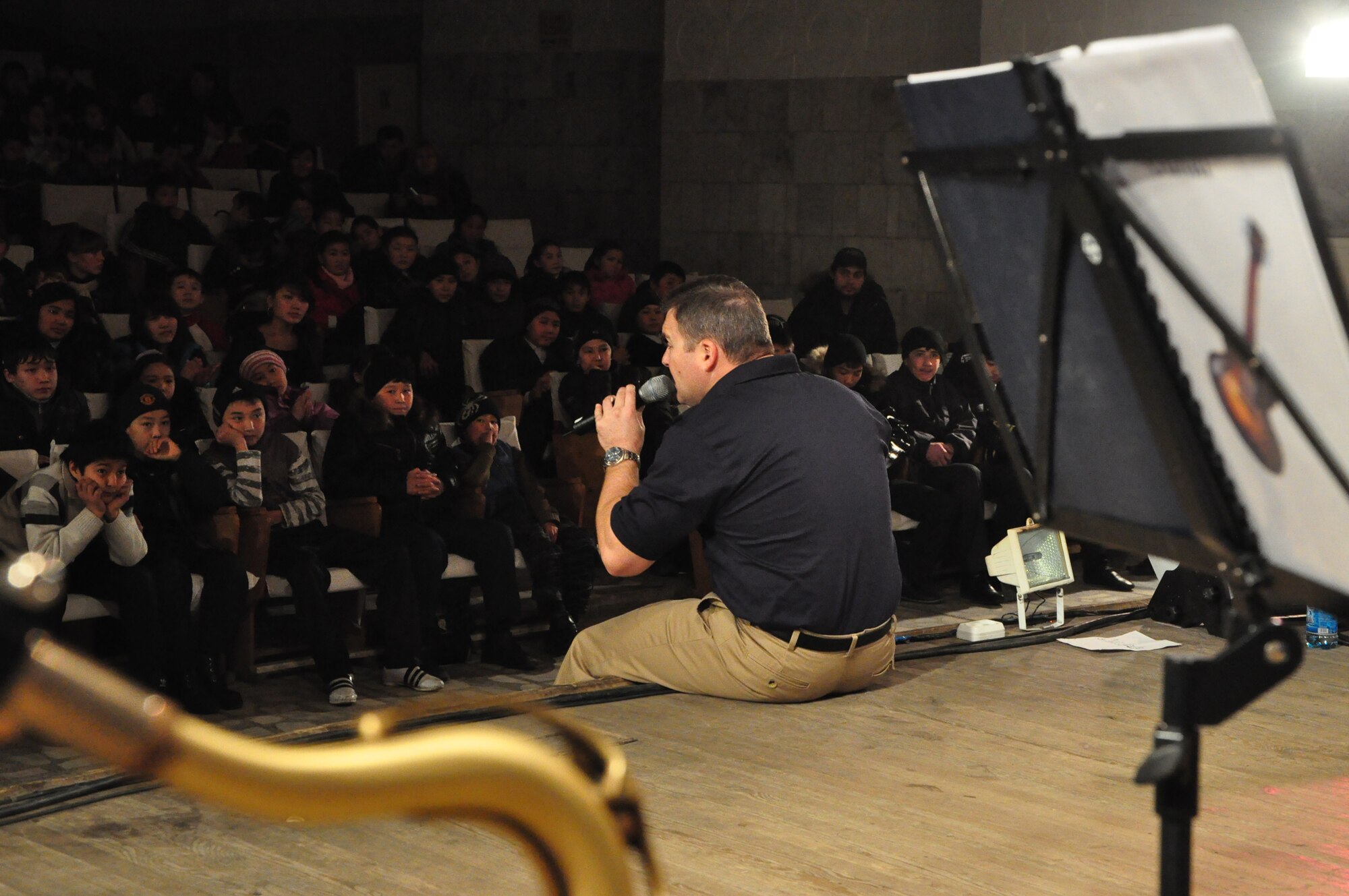 Tech. Sgt. Jamie Gilley serenades students during a U.S. Air Forces Central band "Starlifter" concert at the "Alyi Parus" House of Culture, Kant, Kyrgyzstan, Jan. 31. Starlifter, based out of Scott Air Force Base, Ill., is currently deployed as the U.S. Air Forces Central Expeditionary Band. These dynamic musicians travel throughout the CENTAF Area of Responsibility promoting troop morale, diplomacy and outreach to host nation communities. (U.S. Air Force photo/ Master Sgt. Daniel H. Nathaniel III) 