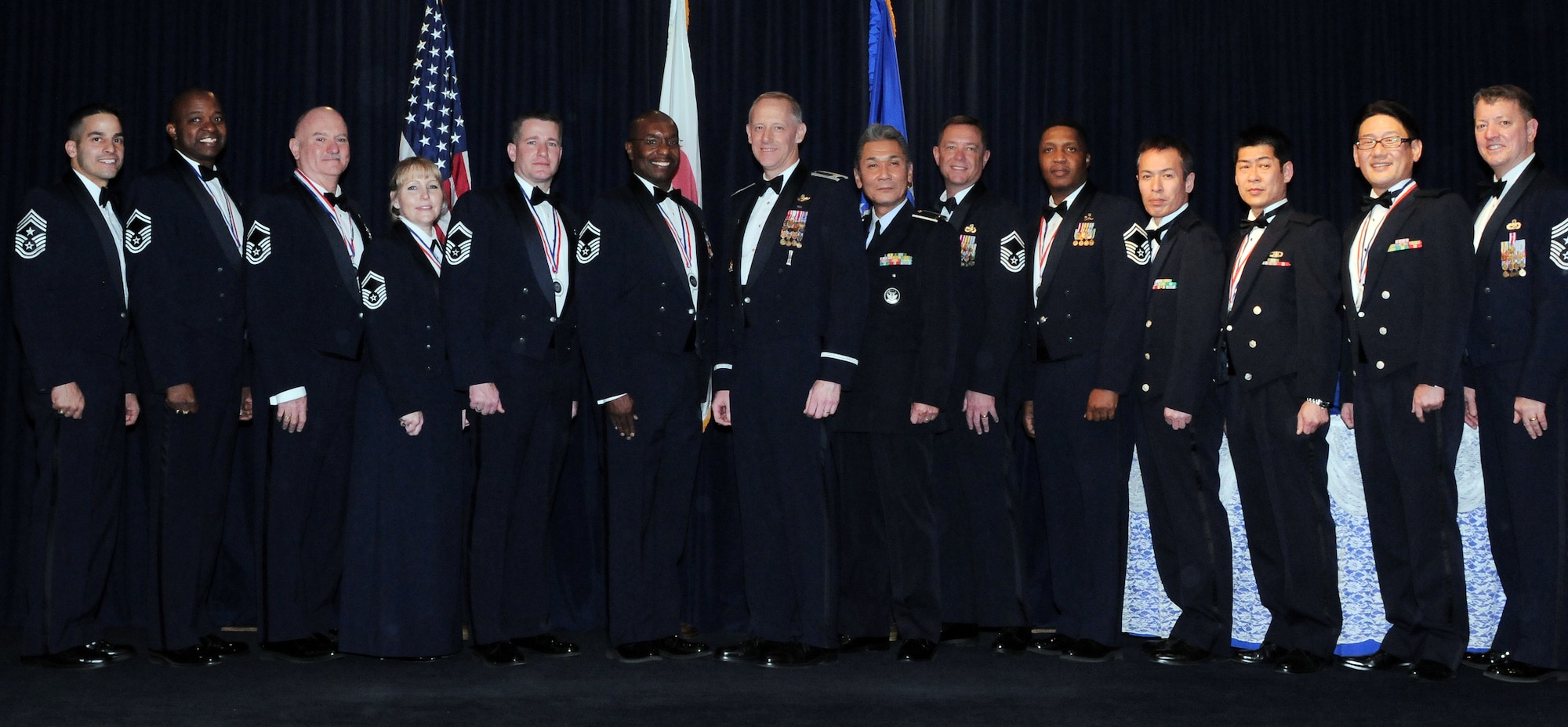 YOKOTA AIR BASE, Japan -- The most recent members from Yokota who were selected for promotion to the rank of chief master sergeant pose for a group photo after the Chief Master Sergeant Recognition ceremony here Jan. 29. Ten Japanese and American servicemembers were selected for promotion to the highest enlisted rank. (U.S. Air Force photo/Airman 1st Class Katrina R. Menchaca)