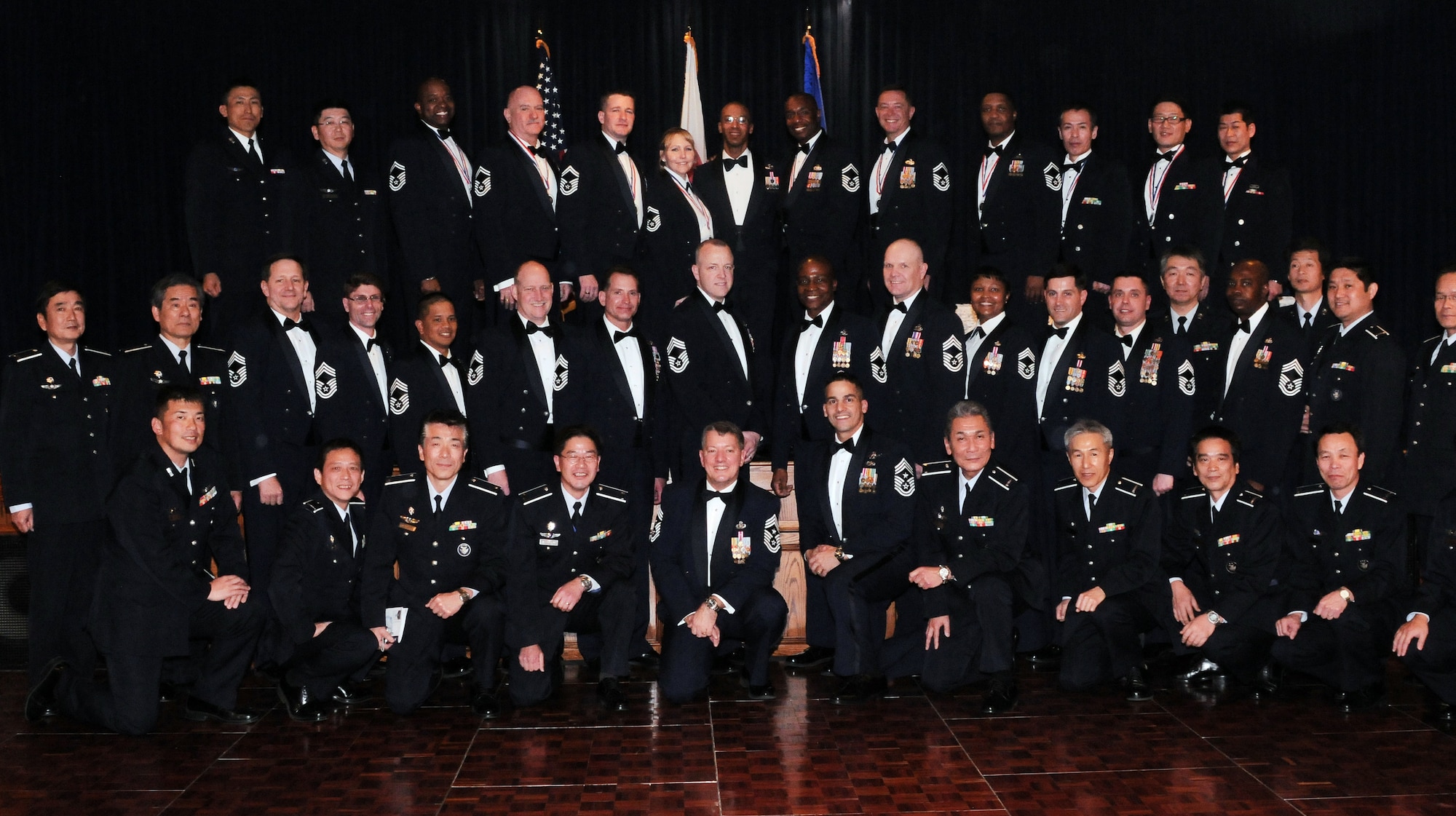YOKOTA AIR BASE, Japan -- Chief master sergeants from around Yokota pose for a group photo after the Chief Master Sergeant Recognition ceremony held at the Enlisted Club here Jan. 29. Seven U.S. Air Force and three Japan Air Self-Defense Force members were selected for promotion to the highest enlisted rank. (U.S. Air Force photo/Airman 1st Class Katrina R. Menchaca)