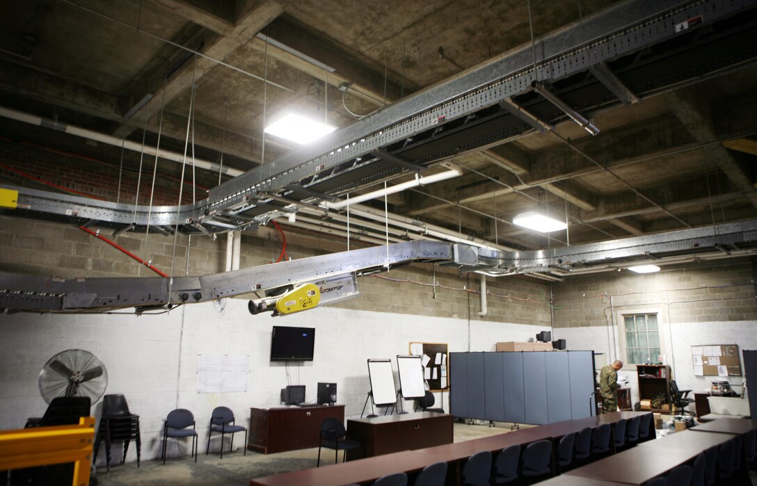 A conveyer belt system hangs from the ceiling inside one of the warehouses belonging to the Supply Management Unit, 2nd Supply Battalion, 2nd Marine Logistics Group, aboard Camp Lejeune, N.C., Feb. 2, 2011. Though the system fell out of use nearly a decade ago, the tempo of today’s society of supply and demand prompted the unit’s leadership to have the conveyer restored. (U.S. Marine Corps photo by Pfc. Franklin E. Mercado)