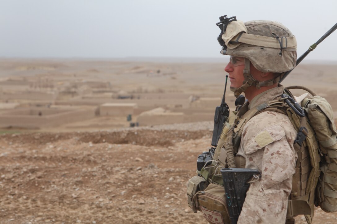 U.S. Marine Corps Cpl. Mitchel R. Atkins, a squad leader with 1st Platoon, Company L, Battalion Landing Team 3/8, 26th Marine Expeditionary Unit, Regimental Combat Team 2, looks over the path that his squad will take prior to leaving on a patrol near Combat Outpost Ouellette in the Helmand province, Afghanistan, Feb. 2, 2011. Elements of the 26th Marine Expeditionary Unit deployed to Afghanistan to provide regional security in Helmand province in support of the International Security Assistance Force.
