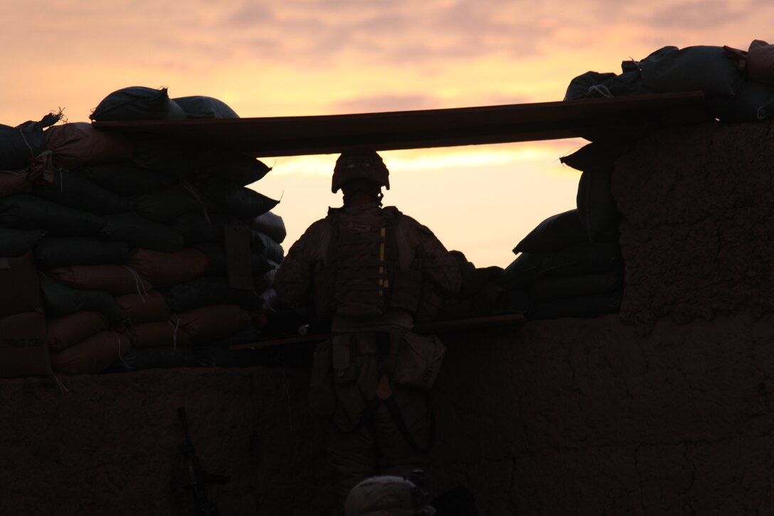 U.S. Marine Corps Lance Cpl. Duane Hopp, a Squad Automatic Weapon gunner with 1st Platoon, Company I, Battalion Landing Team 3/8, 26th Marine Expeditionary Unit, Regimental Combat Team 2, stands post while the sun sets at a patrol base near Combat Outpost Ouellette in Helmand province, Afghanistan, Feb. 2, 2011. Elements of 26th Marine Expeditionary Unit deployed to Afghanistan to provide regional security in Helmand province in support of the International Security Assistance Force.
