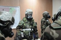 916th Air Refueling Wing leadership embrace the MOPP-donning process, practicing in their chemical gear ensembles, while in Georgia at the wing's Operational Readiness Inspection. (USAF photo by TSgt. Scotty Sweatt, 916ARW/PA)