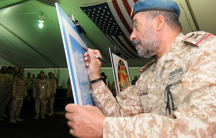 NELLIS AIR FORCE BASE, Nev. -- Maj. Gen. Mohamed Sawaidan Al Gamzi, United Arab Emirates Air Force and Air Defense commander signs a photo after a luncheon during Red Flag 11-2 Jan. 31. The United Arab Emirates air force is participating in a Red Flag exercise to strengthen international relations and training for the second time. (U.S. Air Force photo/Staff Sgt. Benjamin Wilson)