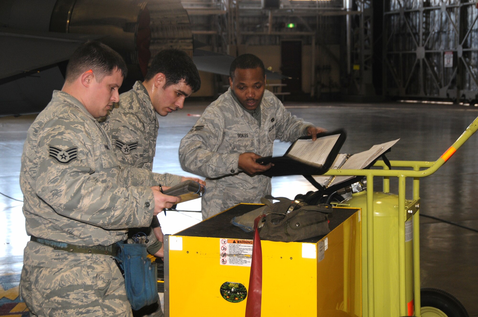 U.S. Air Force Staff Sgt. Branden Paddock, 35th Aircraft Maintenance Squadron load crew chief, and load crew members, Senior Airmen Jacob Milne and Senior Airmen LaBrandon Scales, finish a weapons-loading operation, to include ensuring the aircraft's forms are properly completed, and all composite tool kit components and equipment are accounted for. The trio was named the squadron's load crew of the quarter Jan. 31, 2011, at Misawa Air Base, Japan. (U.S. Air Force photo by Staff Sgt. Jason Bouse/Released)