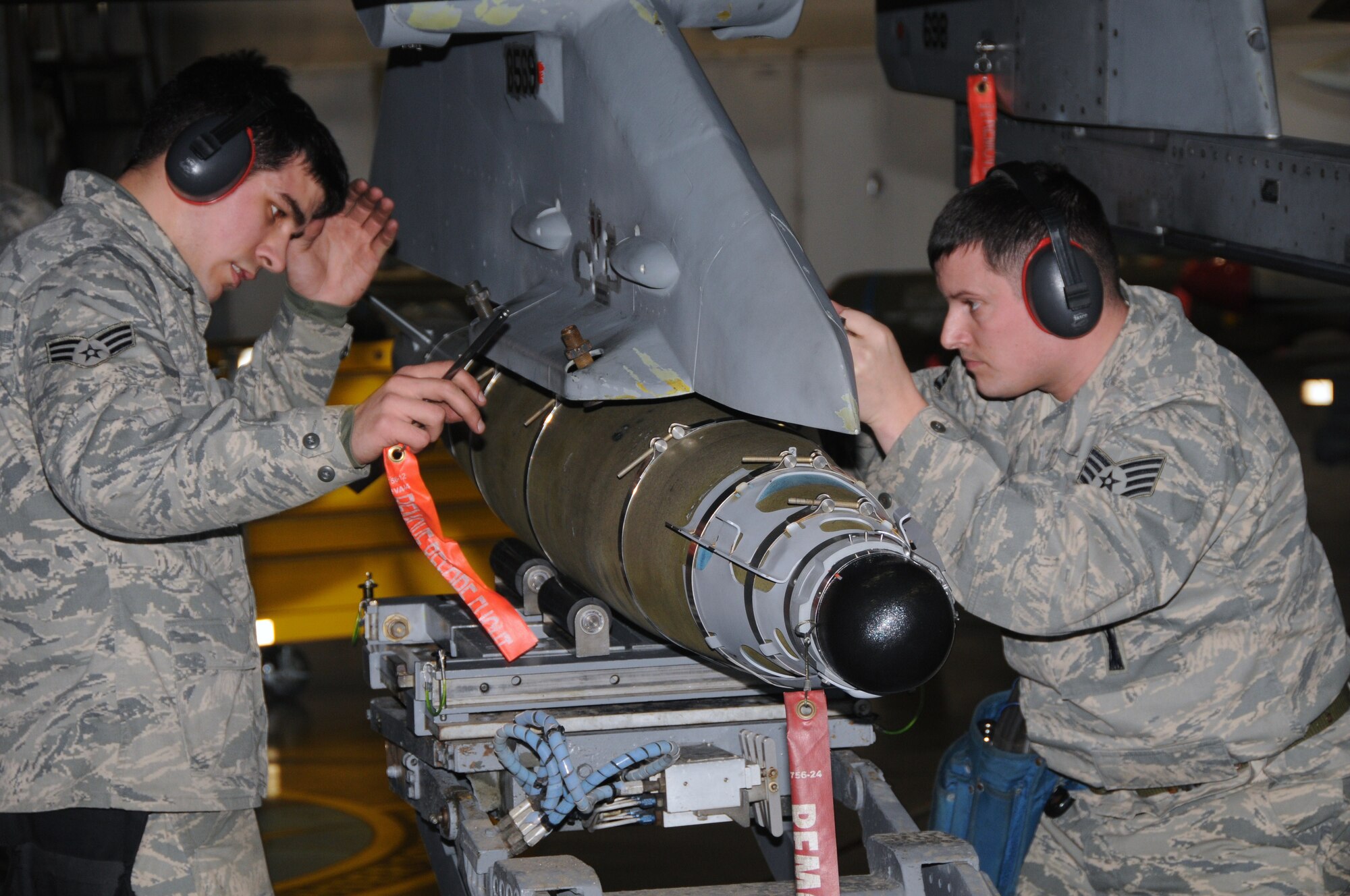 U.S. Air Force Senior Airman Jacob Milne, 35th Aircraft Maintenance Squadron load crew member, and load crew chief, Staff Sgt. Branden Paddock, load a munition on an F-16 Fighting Falcon, Jan. 31, 2011, at Misawa Air Base Japan. Weapons personnel must demonstrate technical proficiency in performing the task within a time standard, with three or fewer technical order errors and no safety or reliability violations. (U.S. Air Force photo by Staff Sgt. Jason Bouse/Released)