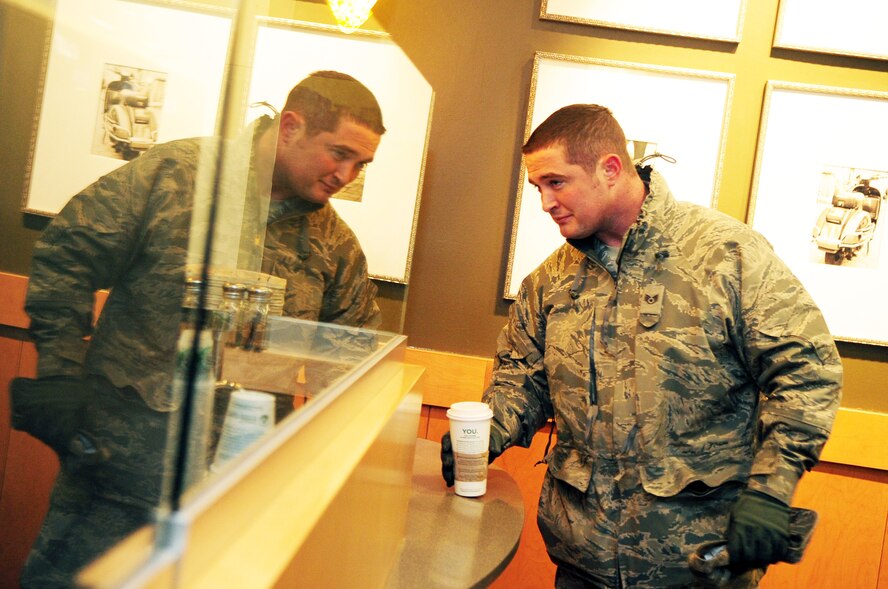 Staff Sgt. Jason Miles, 2nd Maintenance Squadron, recieves a hot drink from a barista at Starbucks, located inside the Base Exchange at Barksdale Air Force Base, La., Feb. 2. Due to recent freezing temeratures in northwest Louisiana, Barksdale Airmen have been frequenting establishments that serve hot drinks in an attempt to combat the cold. (U.S. Air Force photo/Senior Airman Joanna M. Kresge)