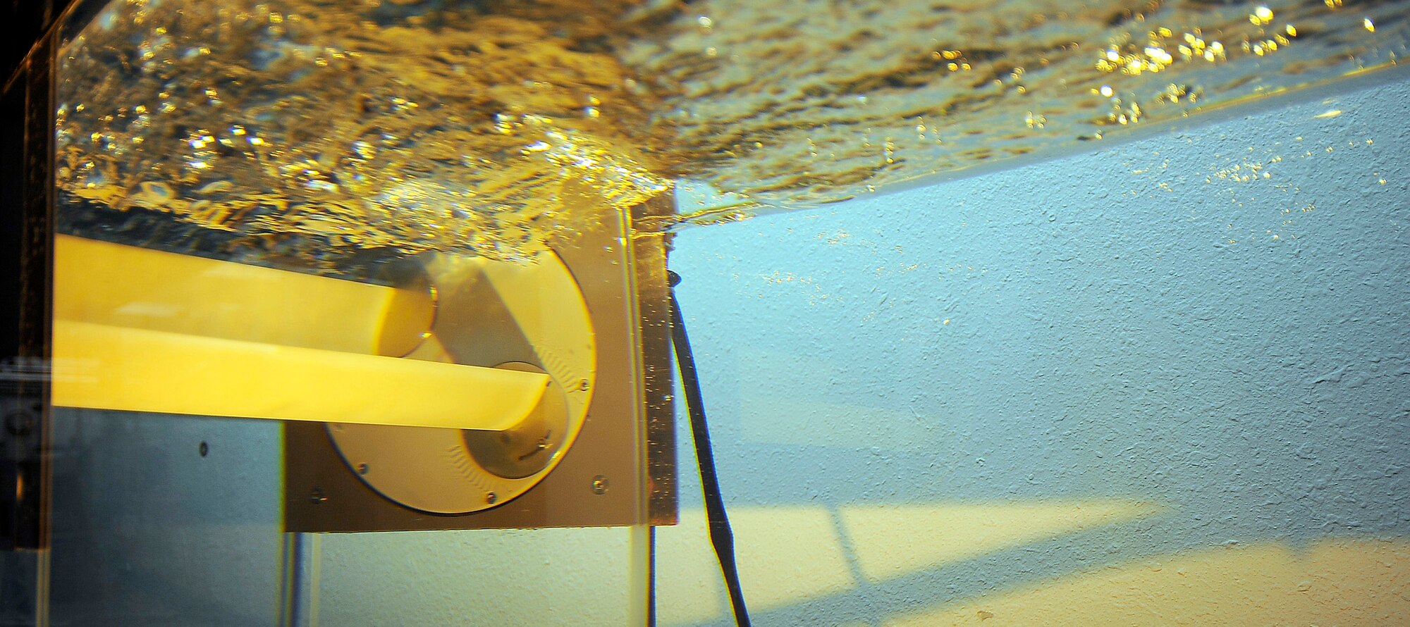 A wave energy converter generates power in a tank Jan. 27, 2010, at the Air Force Academy, Colo. The converter was designed by department of aeronautics researchers Dr. Stefan Siegel and Jurgen Seidel. (U.S. Air Force photo/Rachel Boettcher)