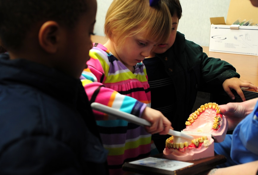 MOODY AIR FORCE BASE, Ga.-- Kimberly, daughter of Staff Sgt. Jeffery Mullins, brushes a teeth model Feb. 1.  After the children were taught how to properly brush their teeth, they used a model to show off what they learned. (U.S. Air Force photo/Senior Airman Stephanie Mancha)(RELEASED)